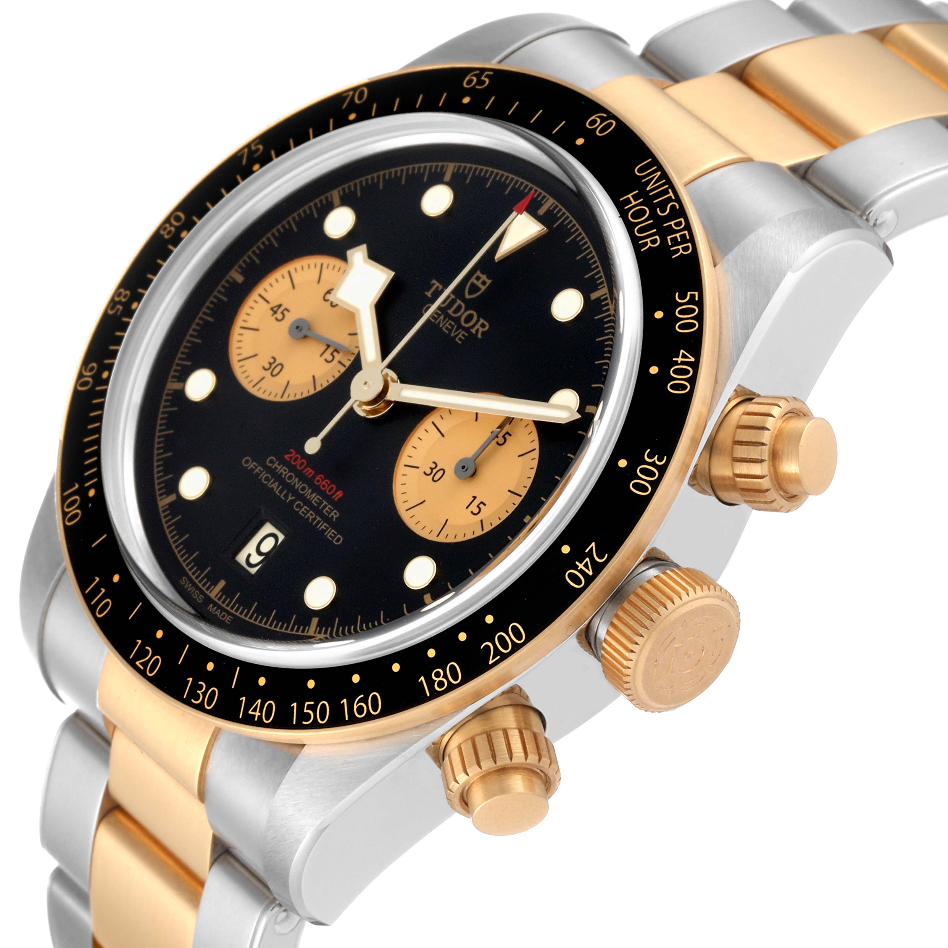 The Tudor Heritage Black Bay 79363N Men
s Steel and Gold (two tone) Black Dial 79363N Men
s Steel and Gold (two tone) Black Dial watch is shown at an angle, highlighting its gold and steel bracelet, black bezel, and dial with chronograph subdials.