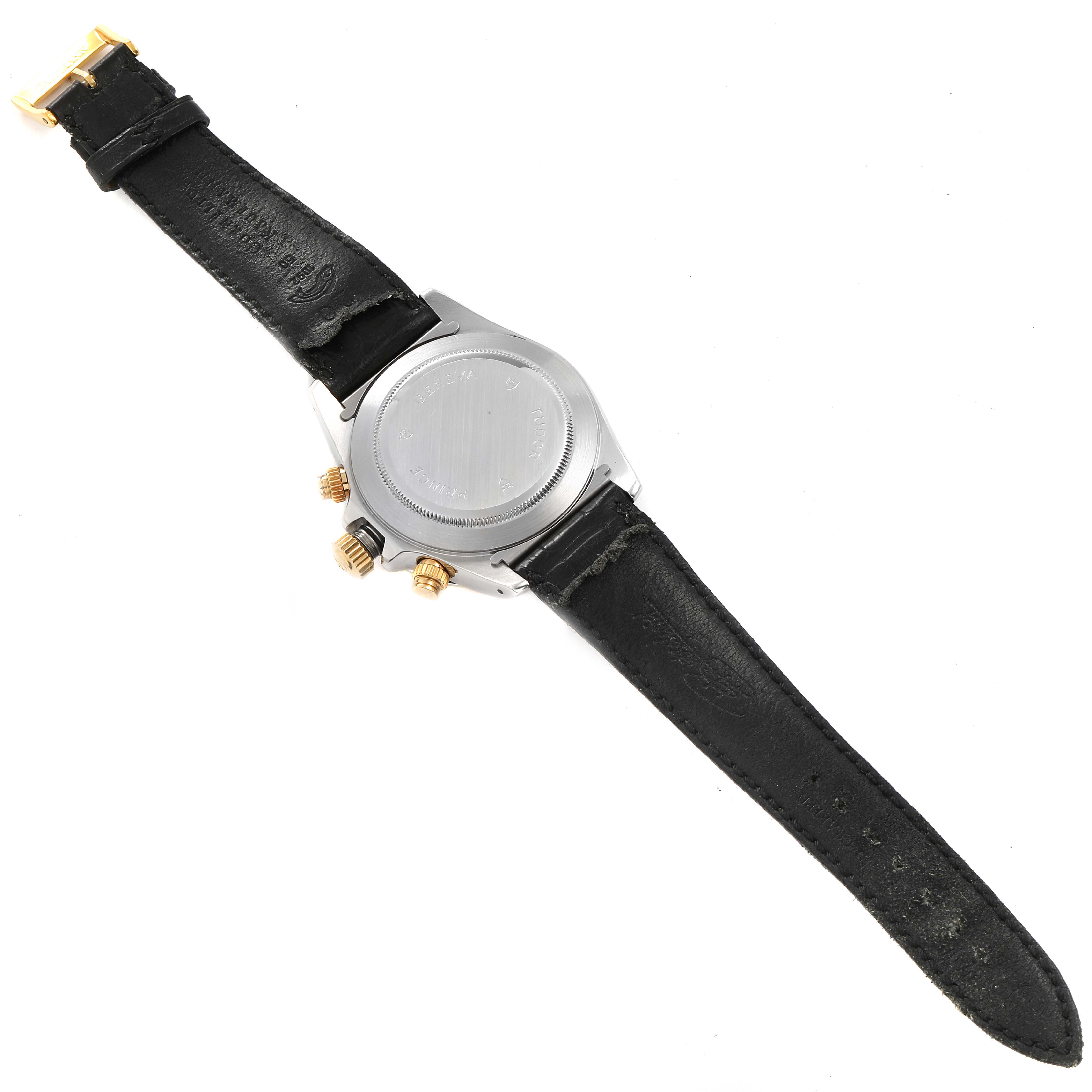 This image shows the back view of a Tudor Tiger 79263 Men's Steel and Gold (two tone) White Dial 79263 Men's Steel and Gold (two tone) White Dial watch, highlighting its case back, black leather strap, and gold-tone pushers and crown.