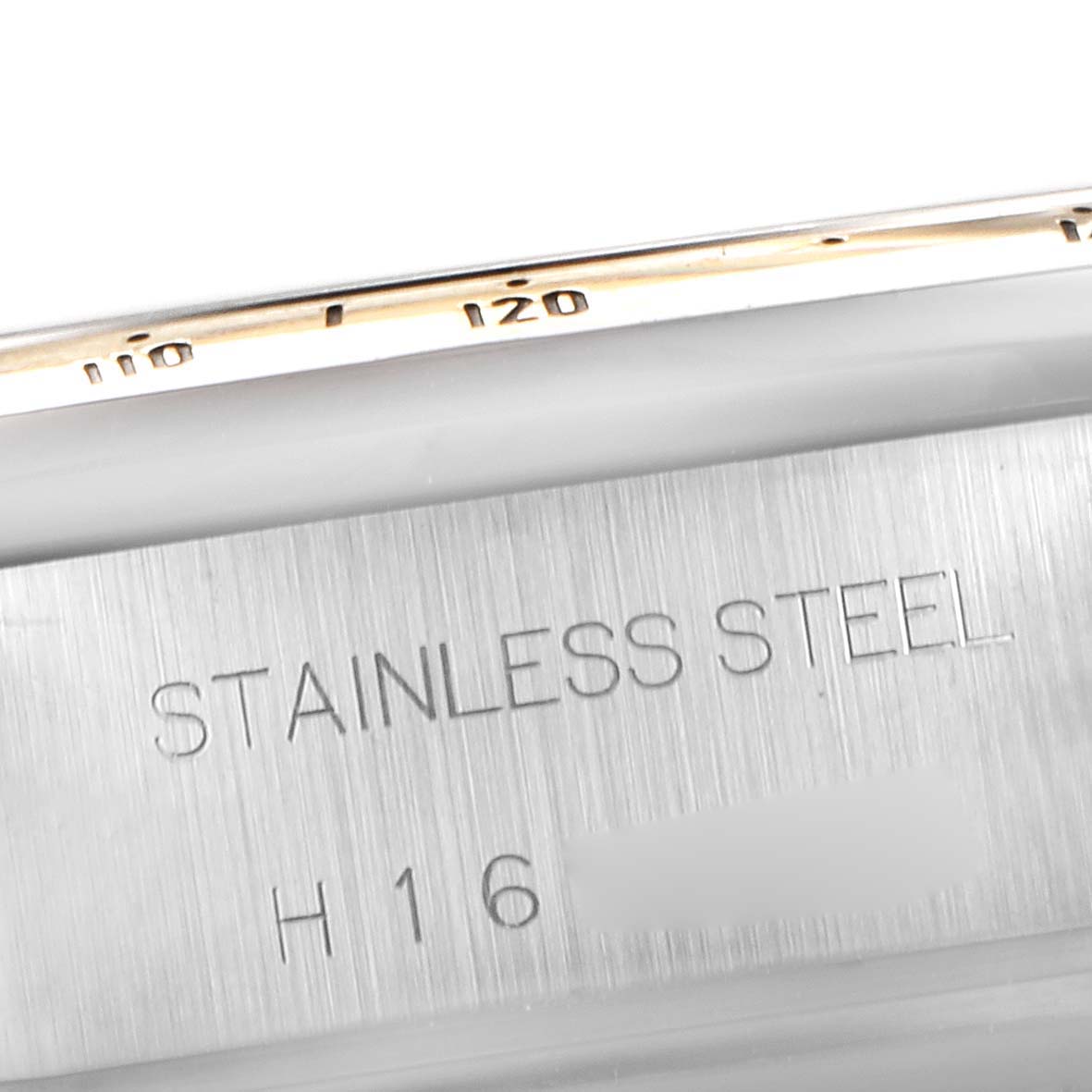 The image shows a close-up of the stainless steel caseback of a Tudor Tiger 79263 Men's Steel and Gold (two tone) White Dial 79263 Men's Steel and Gold (two tone) White Dial model watch, focusing on the material inscription.