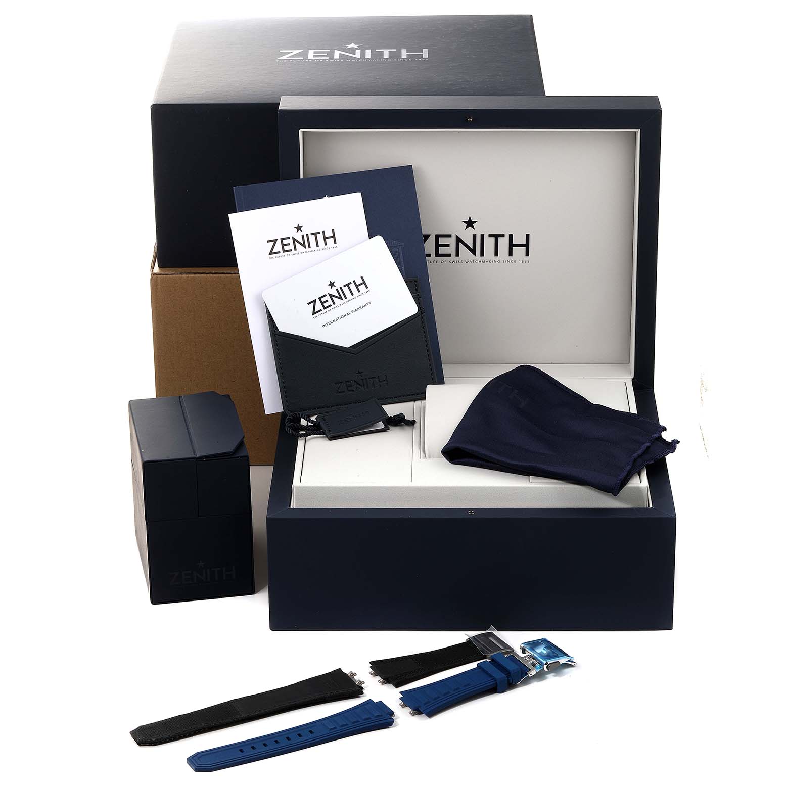 The image shows the Zenith Defy 95.9100.9004/01.I001 Men's Titanium Blue Dial 95.9100.9004/01.I001 Men's Titanium Blue Dial watch's packaging and accessories, including the box, warranty cards, and multiple straps.