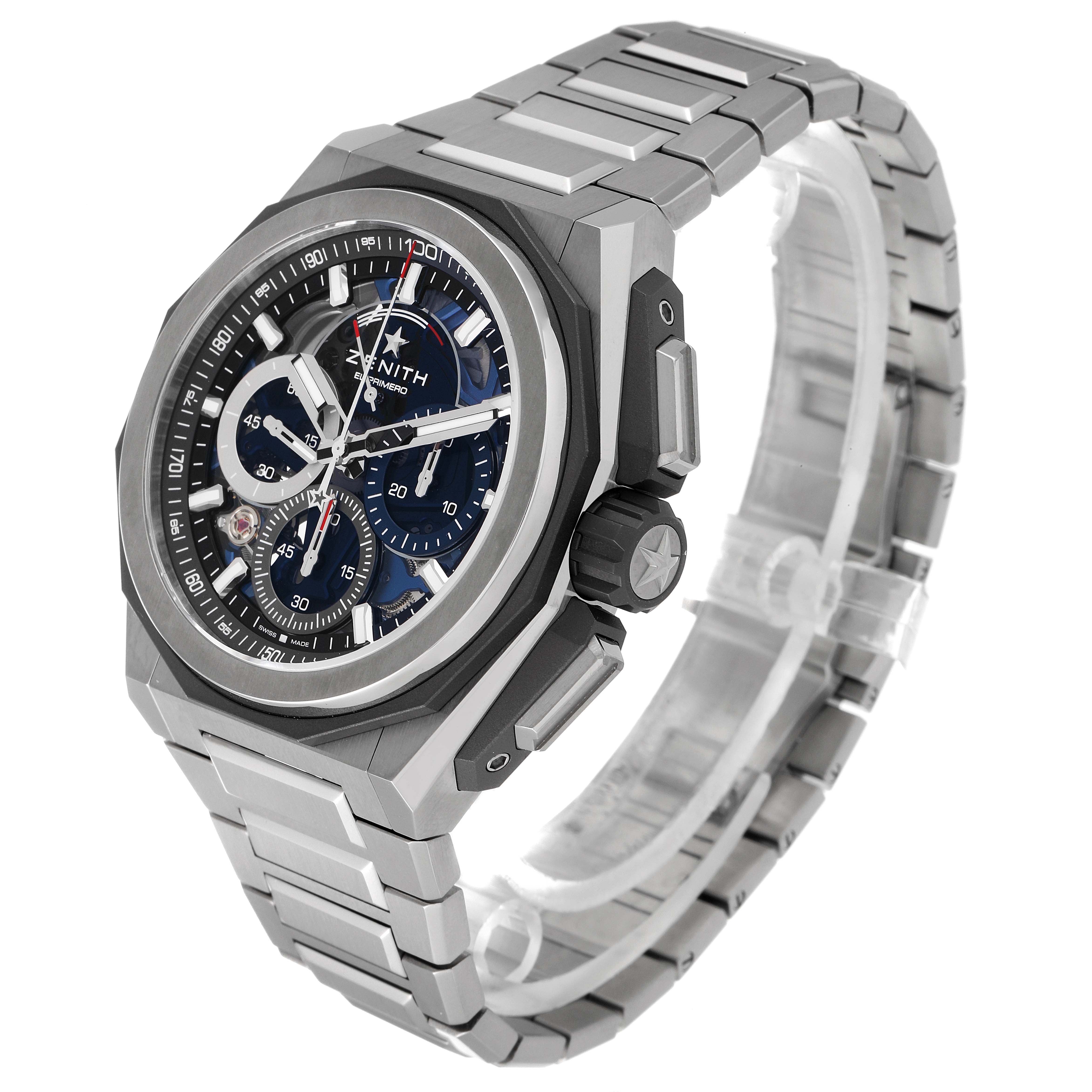 The image shows a Zenith Defy 95.9100.9004/01.I001 Men's Titanium Blue Dial 95.9100.9004/01.I001 Men's Titanium Blue Dial model watch at a three-quarter angle, highlighting the face, bezel, crown, and metal bracelet.