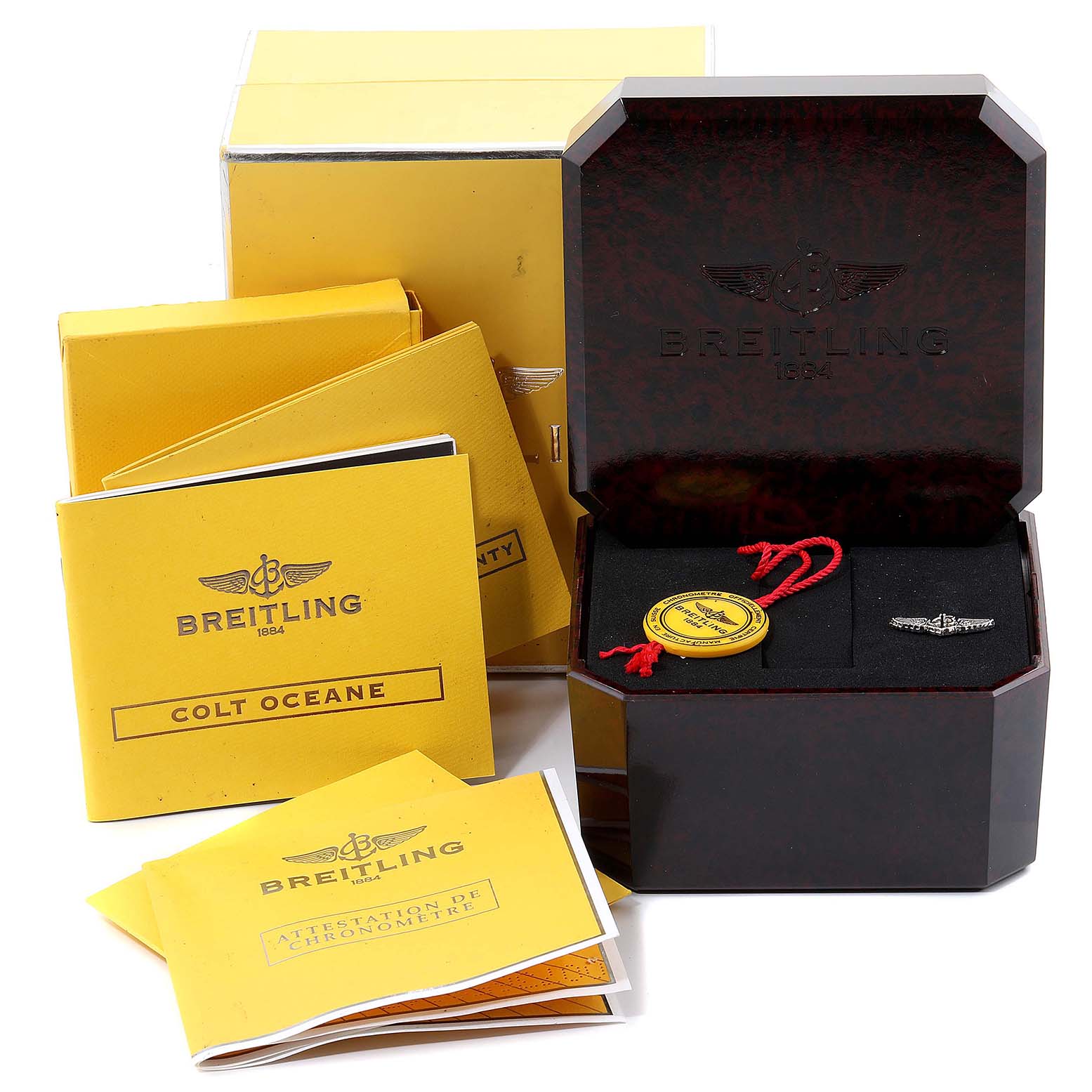 The image shows the packaging, manuals, and accessories for the Breitling A77380 Women
s Stainless Steel Silver Dial A77380 Women
s Stainless Steel Silver Dial Colt Oceane Stainless Steel Diamond Ladies Watch A77380 from a front angle.