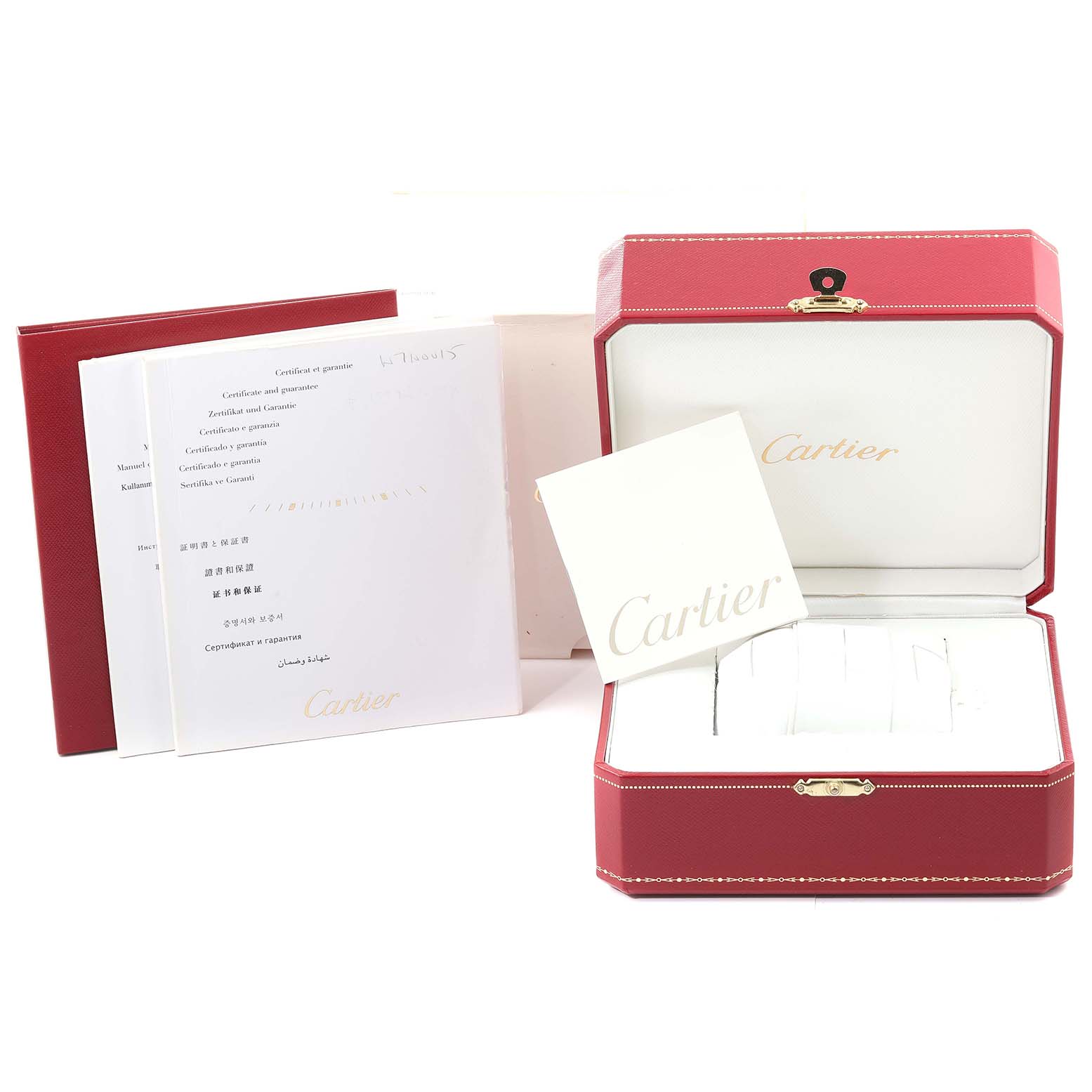 The image shows the packaging and documentation, including the box and booklets for a Calibre de Cartier watch by Cartier.
