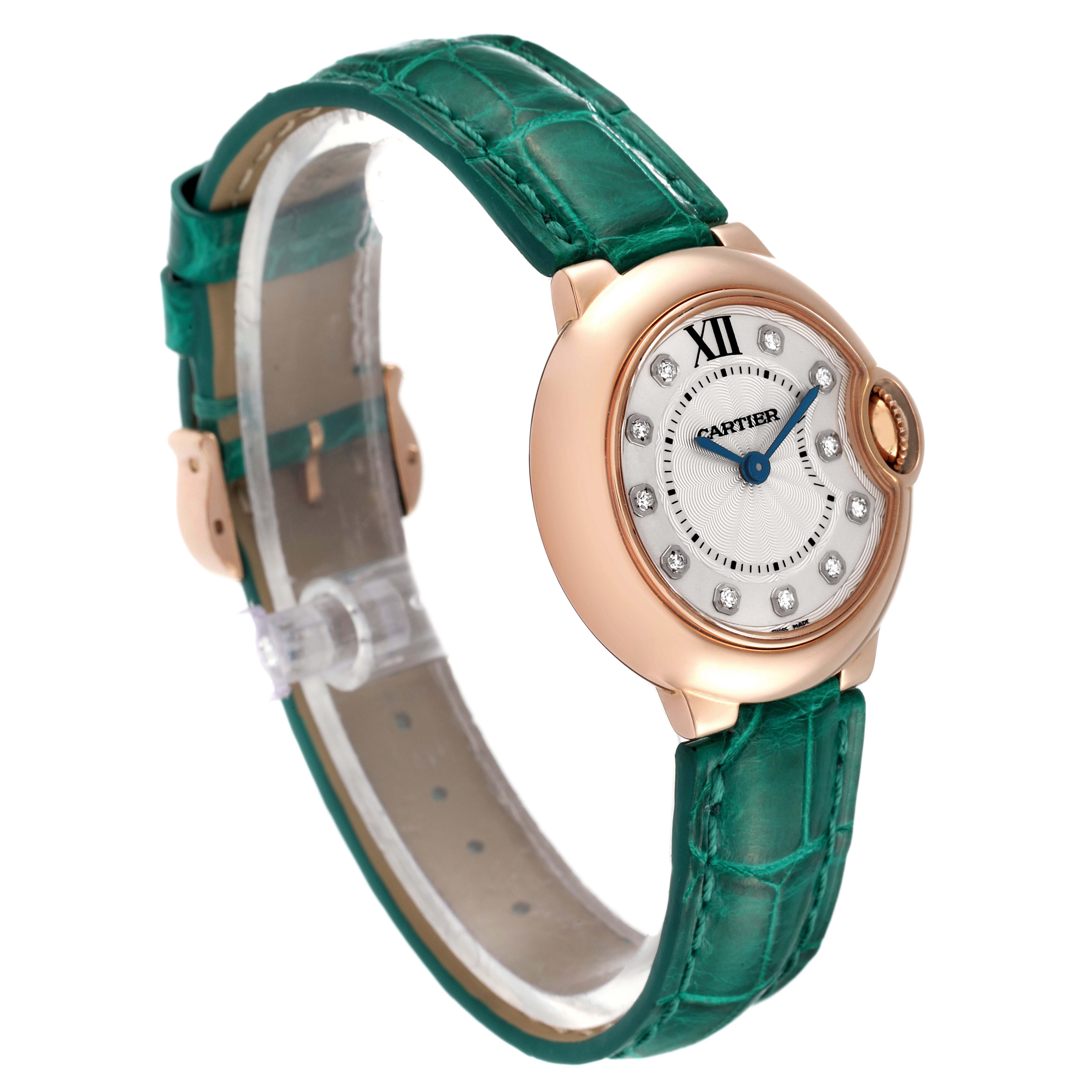 The image shows a side-angle view of the Cartier Ballon Bleu WE902050 Women's Rose Gold Silver Dial WE902050 Women's Rose Gold Silver Dial watch, highlighting its green strap, round face, and diamond hour markers.
