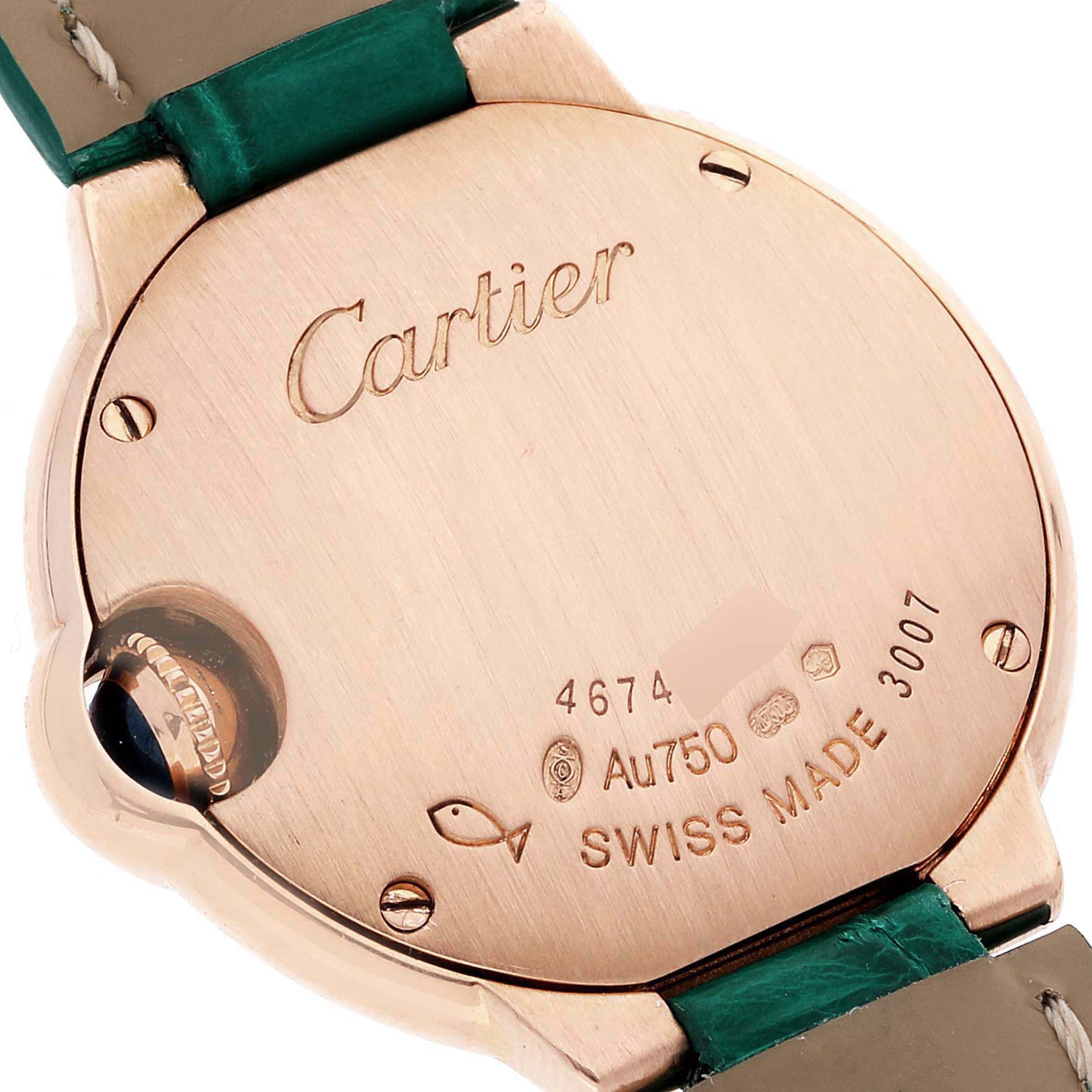 This image shows the back casing of the Cartier Ballon Bleu WE902050 Women's Rose Gold Silver Dial WE902050 Women's Rose Gold Silver Dial watch, highlighting the brand engravings and a portion of the strap.