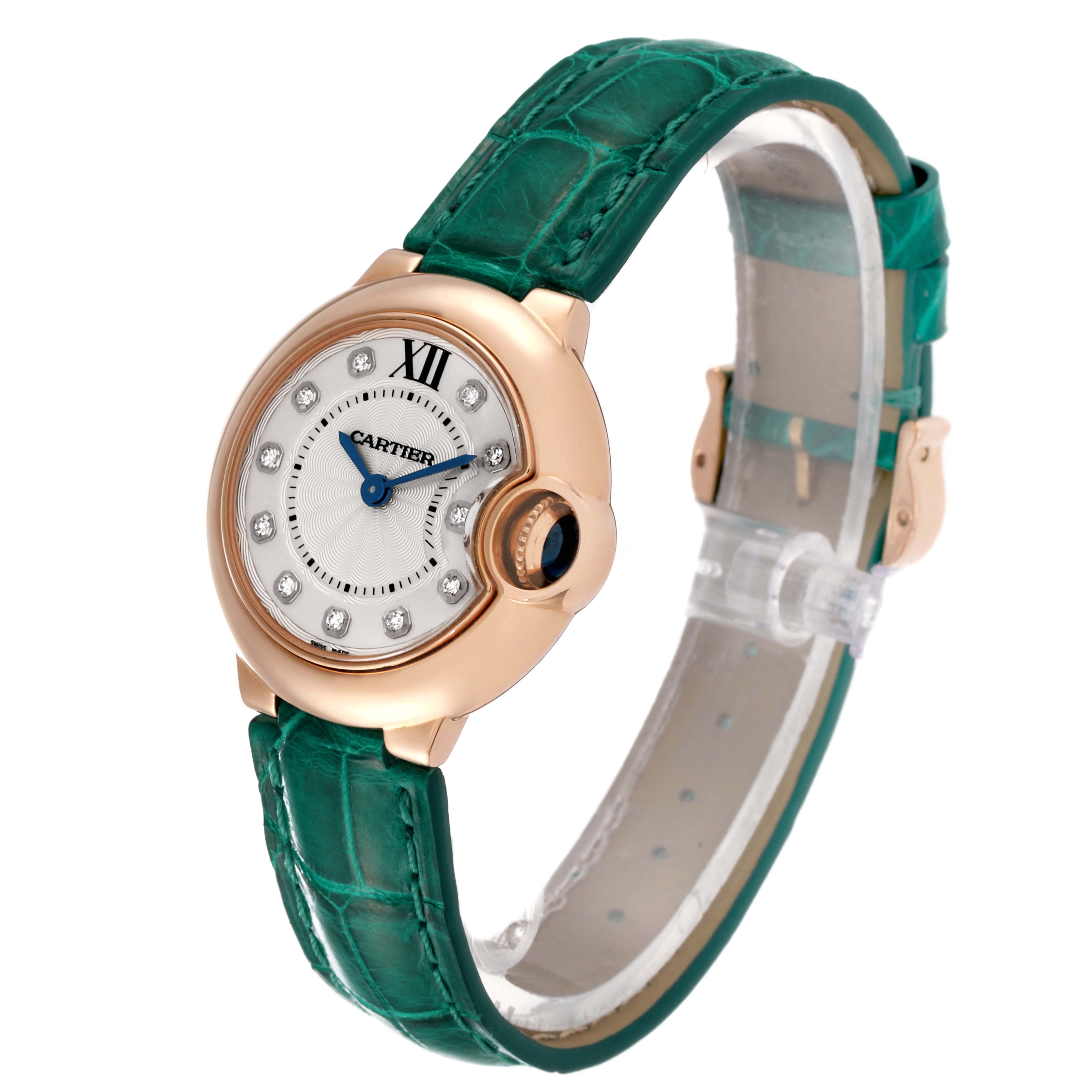 This Cartier Ballon Bleu WE902050 Women's Rose Gold Silver Dial WE902050 Women's Rose Gold Silver Dial watch is shown at a slight angle, highlighting its face, green strap, and side profile including the crown.