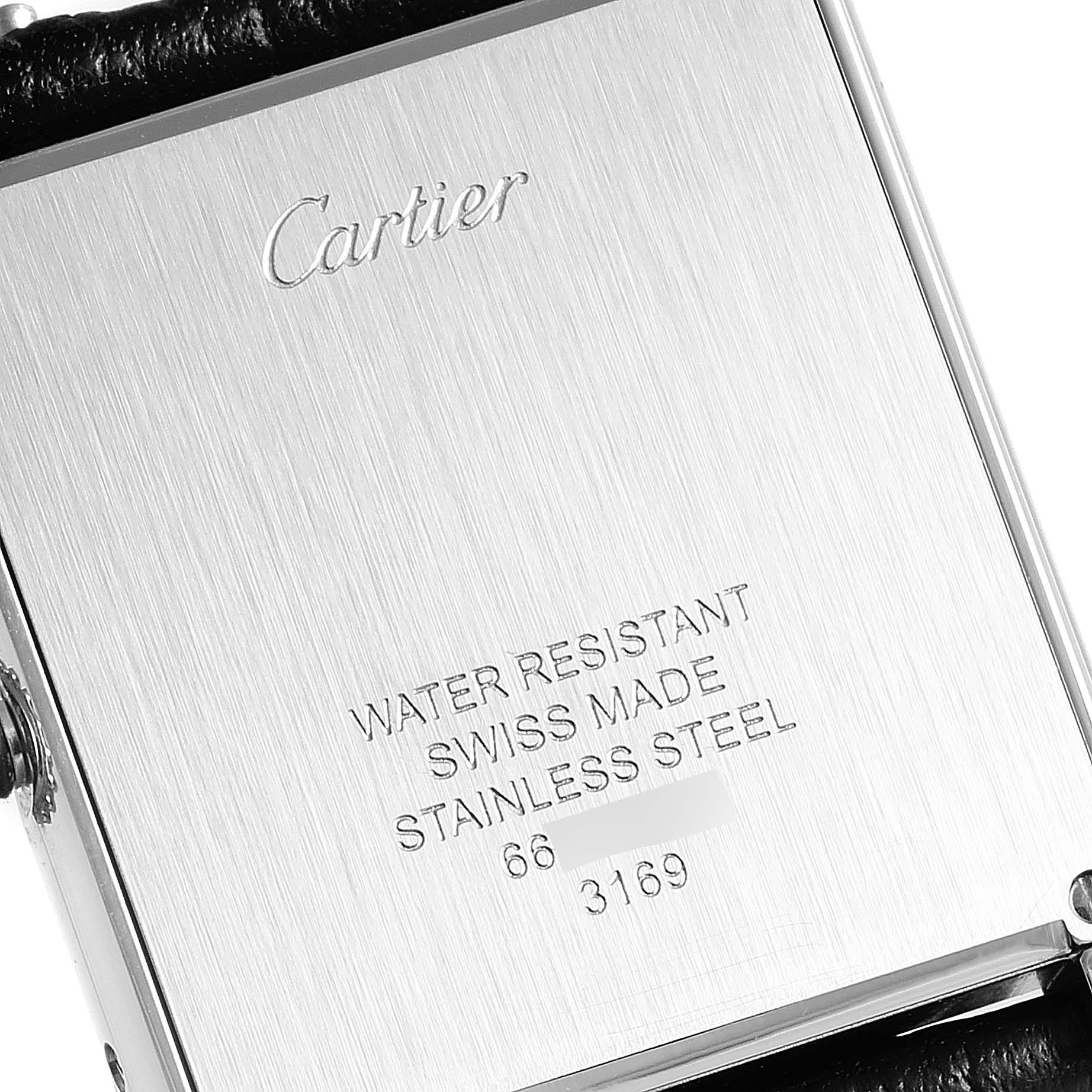 This image shows the back of a Tank Solo watch by Cartier, displaying brand engraving and product details.