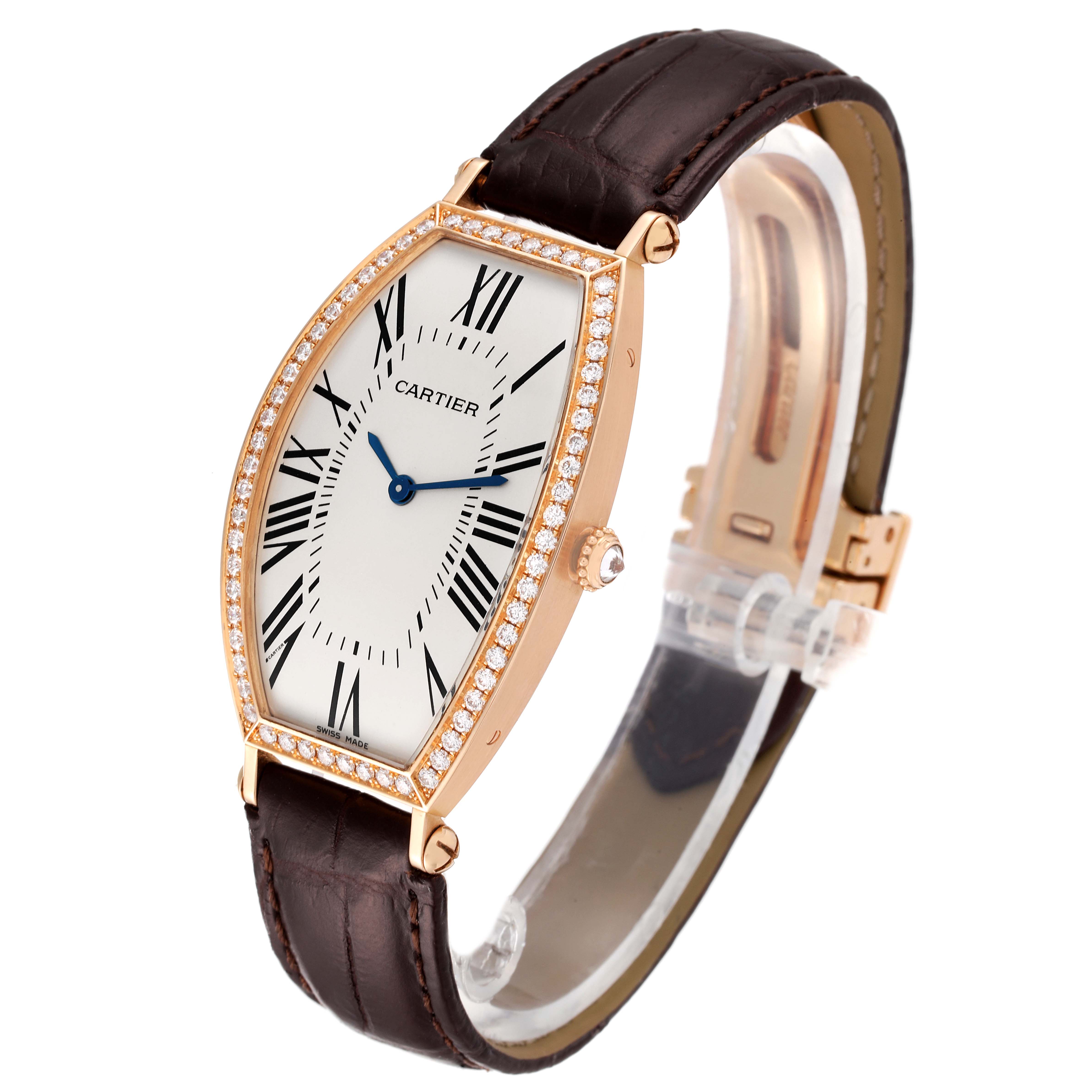 This Tonneau model watch by Cartier is shown from a three-quarter angle, displaying the face, bezel, crown, and leather strap.