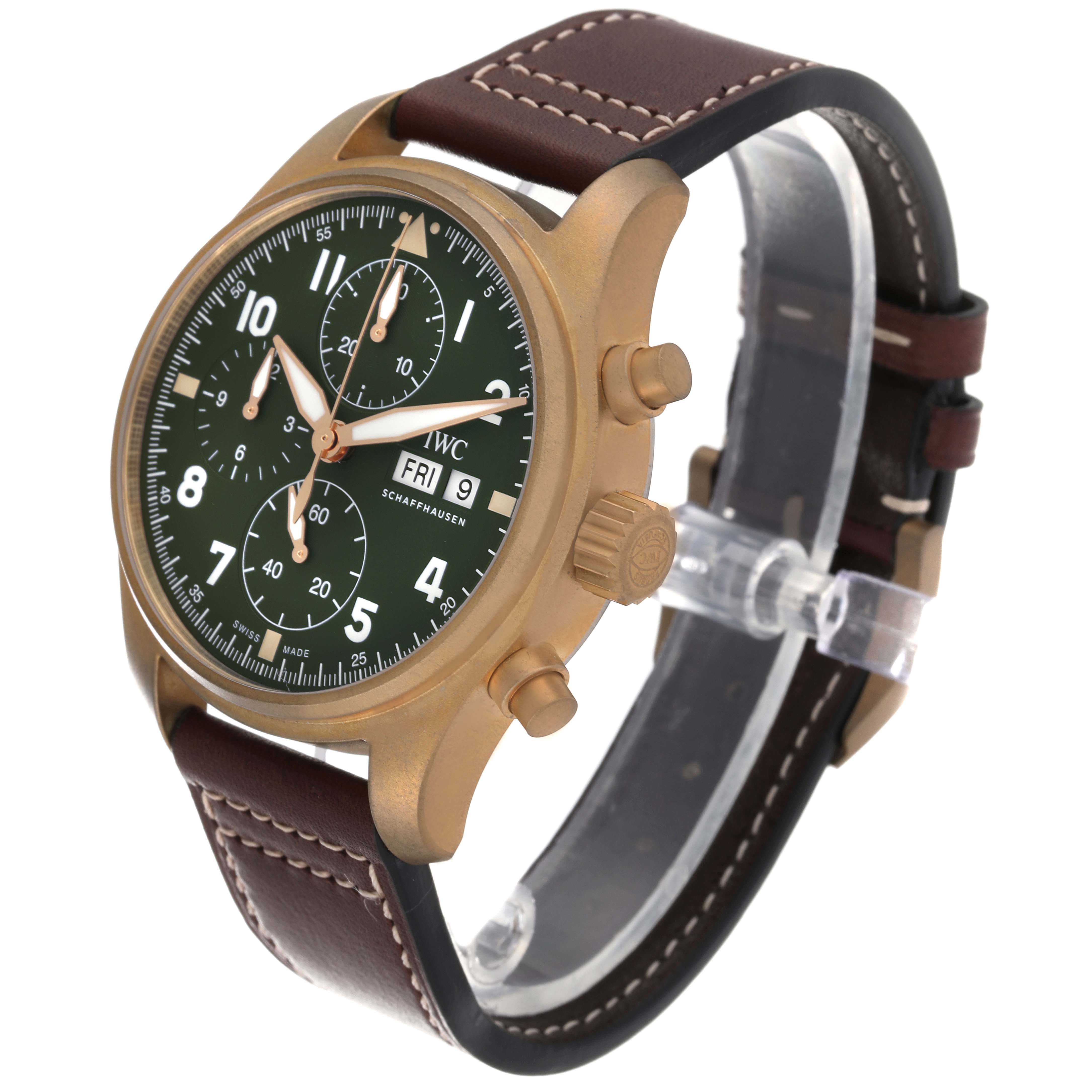 The IWC Pilot IW387902 Men's Bronze Green Dial IW387902 Men's Bronze Green Dial watch is shown at a three-quarter angle, displaying its green dial, crown, pushers, and brown leather strap.