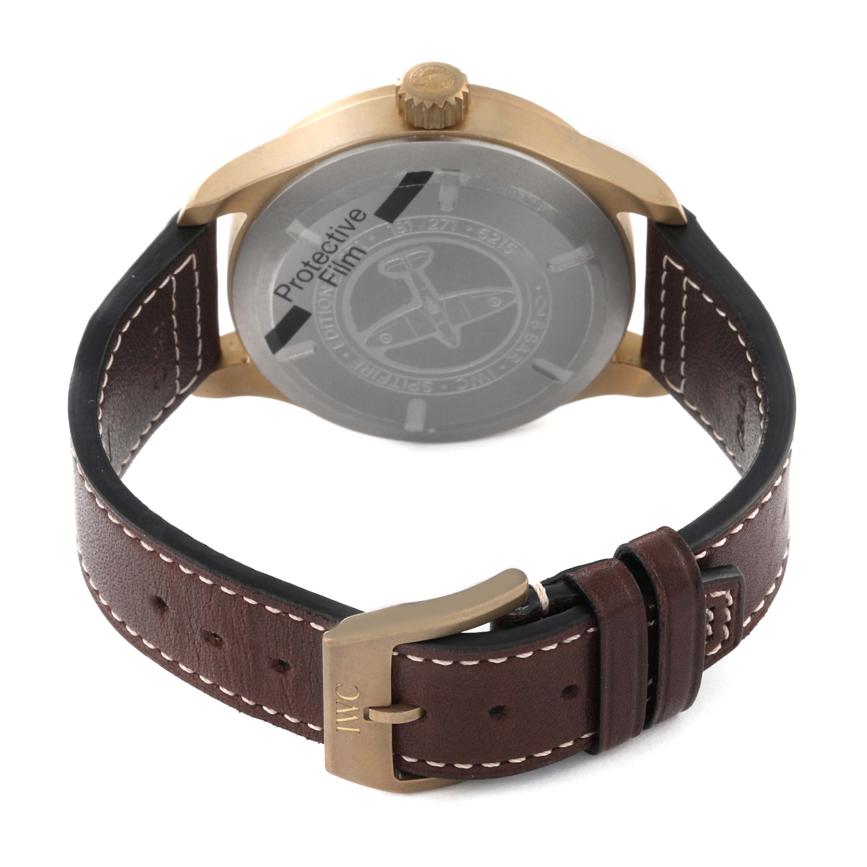 The image shows the back view of an IWC Pilot IW327101 Men's Bronze Green Dial IW327101 Men's Bronze Green Dial model watch, highlighting its case back, crown, and leather strap with the IWC logo on the buckle.