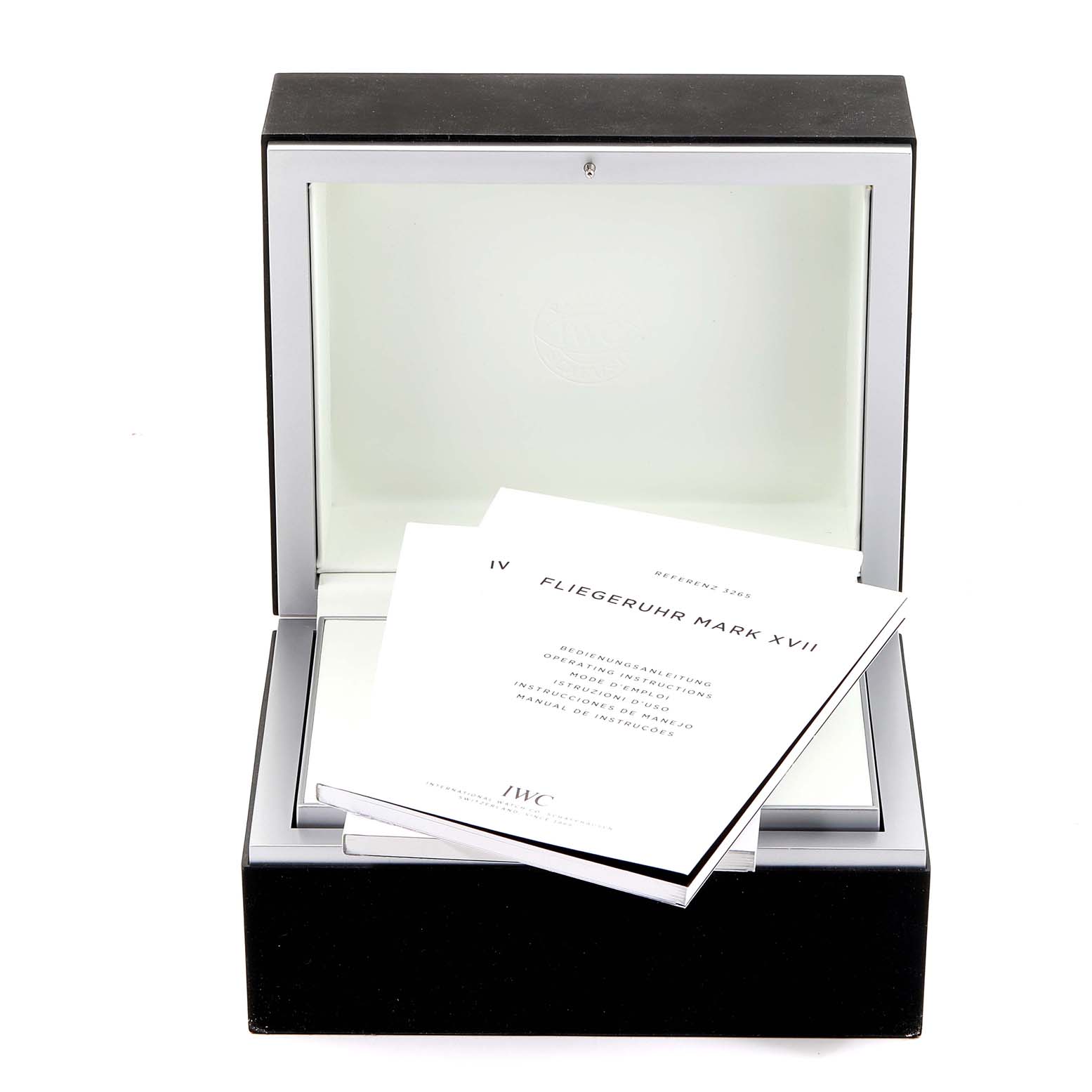 The image shows an IWC Pilot IW326504 Men's Stainless Steel Black Dial IW326504 Men's Stainless Steel Black Dial watch box and instruction manuals for the Fliegeruhr Mark XVII model.