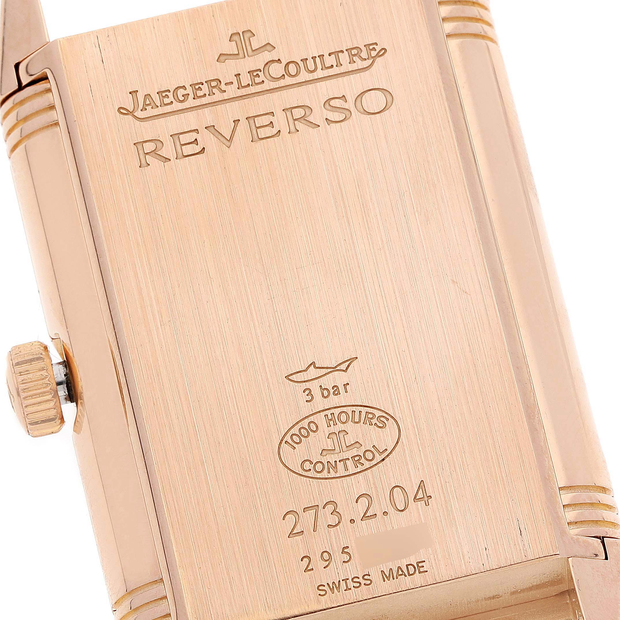 The image shows the back case of a Reverso model watch by Jaeger-LeCoultre, featuring its engravings and crown.