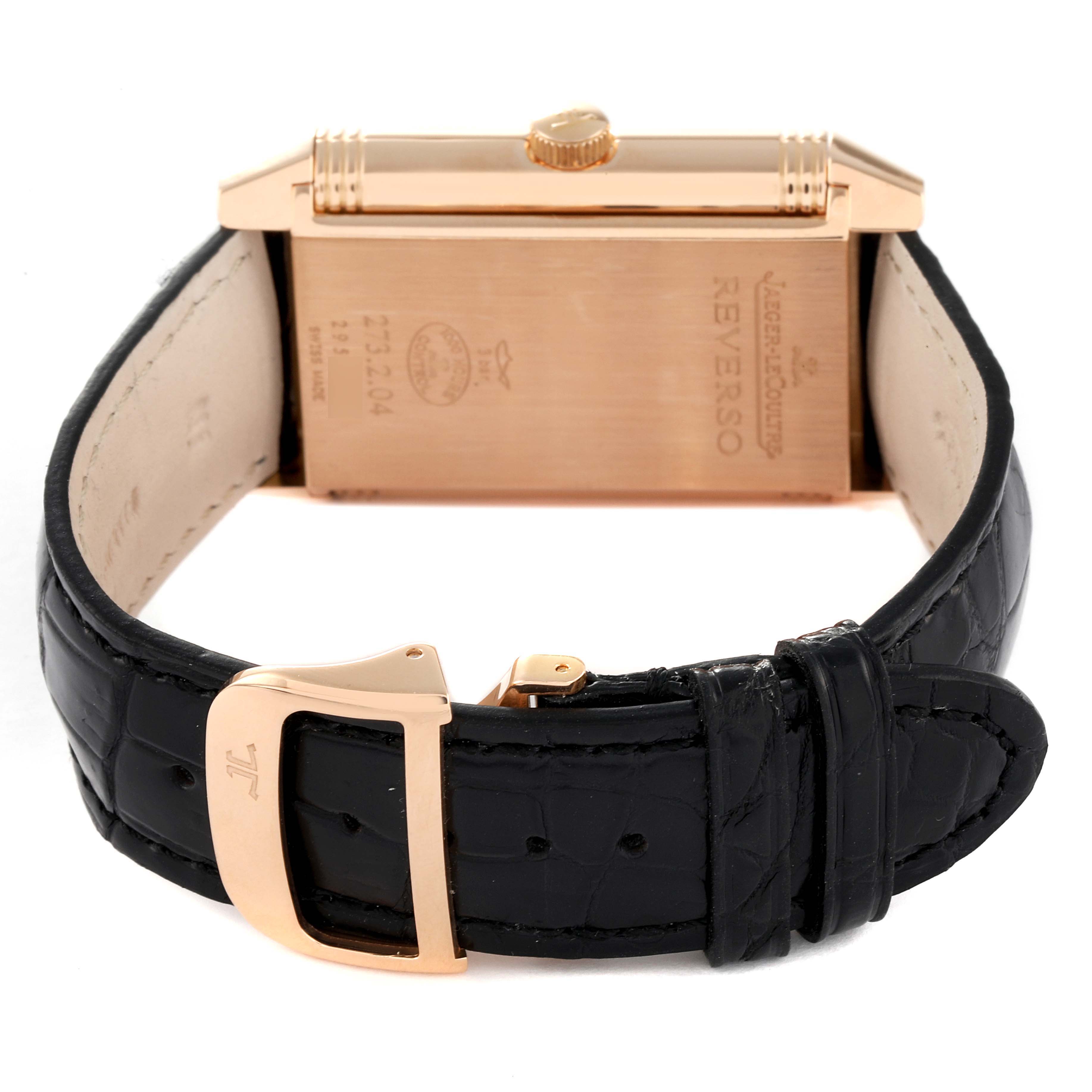 The image shows the back and strap of a Jaeger LeCoultre Reverso Q3732420 Men's Rose Gold Silver Dial Q3732420 Men's Rose Gold Silver Dial watch, highlighting the gold casing and black leather band.