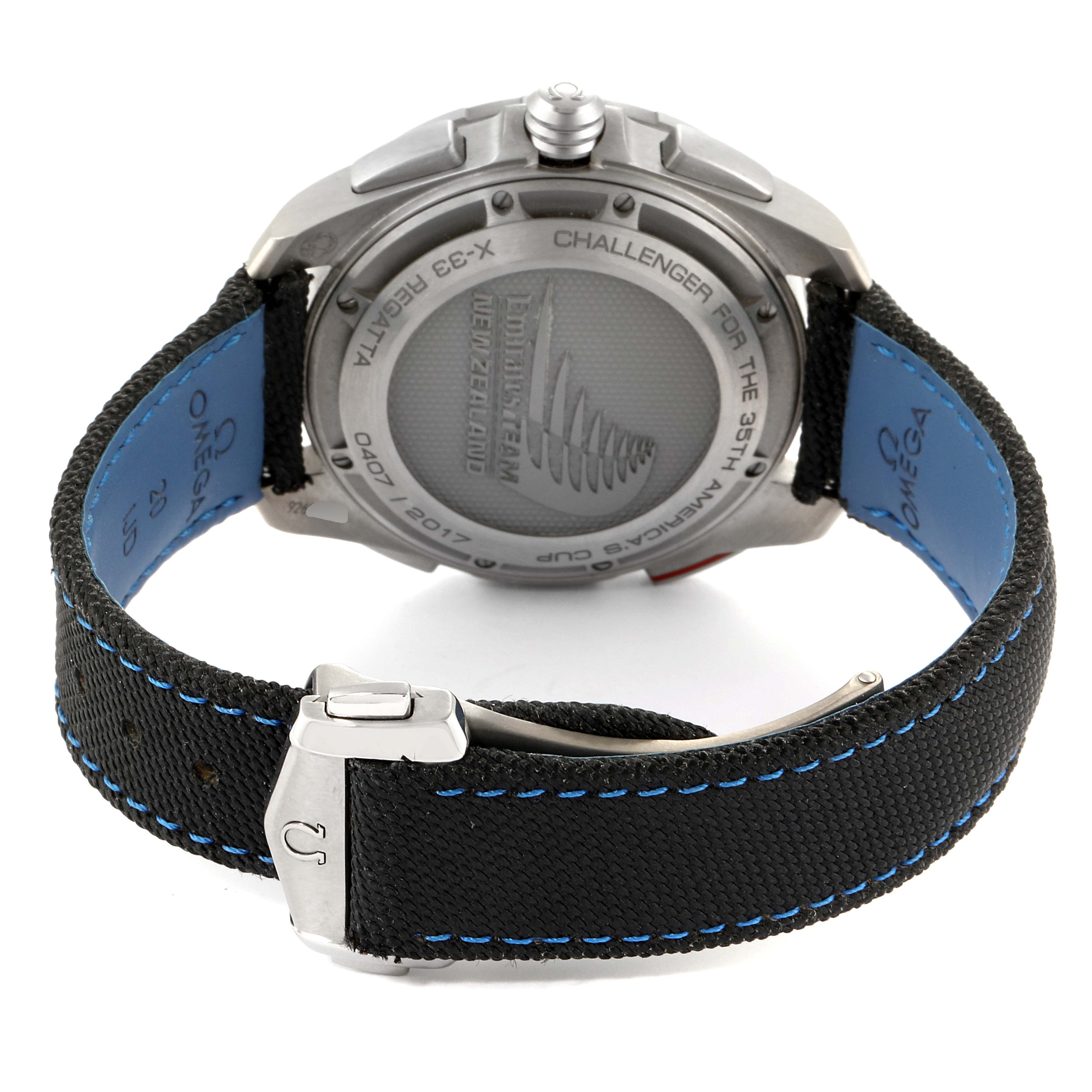 The image shows the back view of the Omega Speedmaster 318.92.45.79.01.001 Men's Titanium Black Dial 318.92.45.79.01.001 Men's Titanium Black Dial watch, highlighting the strap, buckle, and engraved case back.