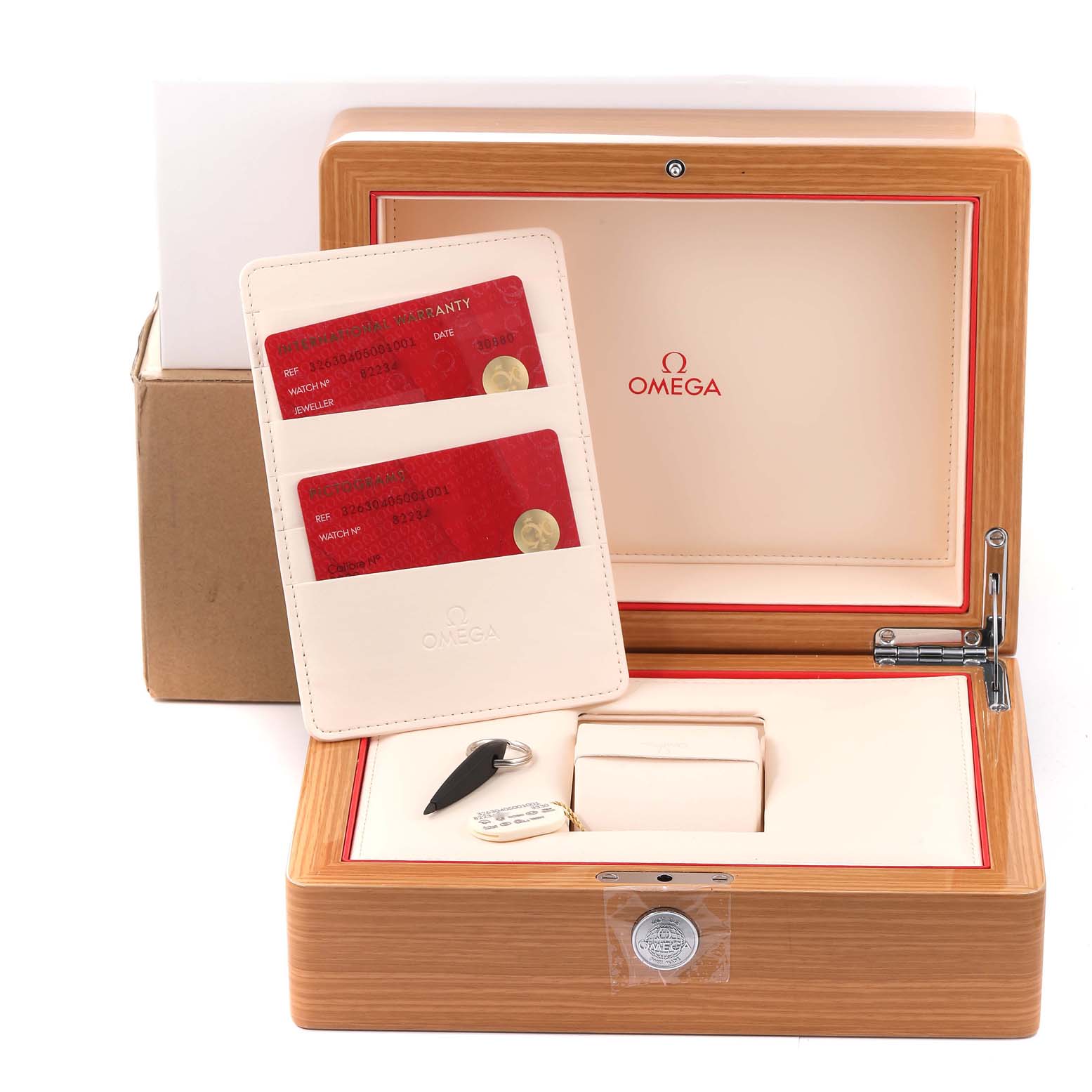 This image shows the open box, warranty cards, and accessories for an Omega Speedmaster 326.30.40.50.01.001 Men's Stainless Steel Black Dial 326.30.40.50.01.001 Men's Stainless Steel Black Dial watch.