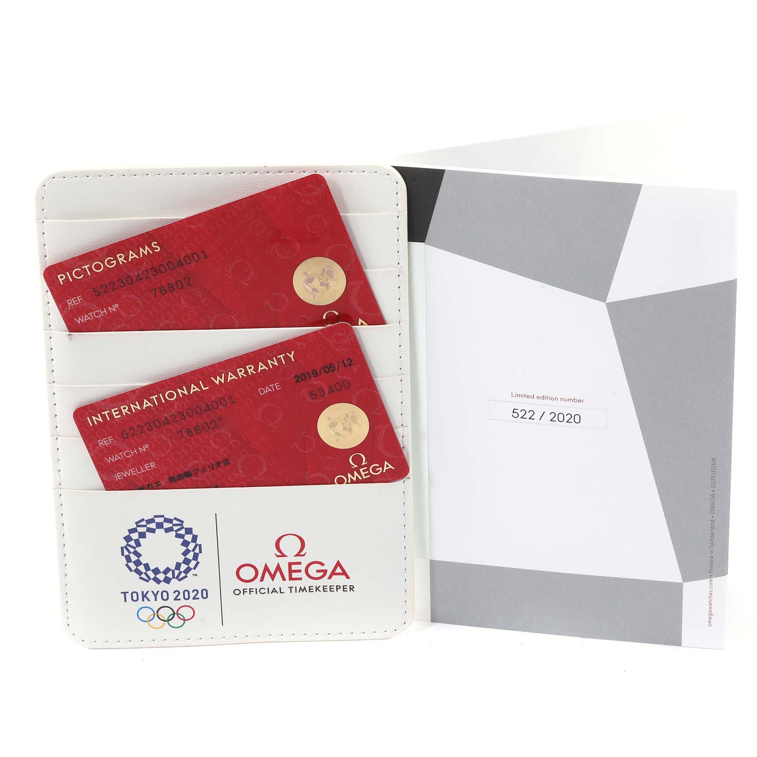 The image shows a warranty cardholder and manual for the Omega Speedmaster 522.30.42.30.04.001 Men's Stainless Steel White Dial 522.30.42.30.04.001 Men's Stainless Steel White Dial watch, featuring Tokyo 2020 branding.