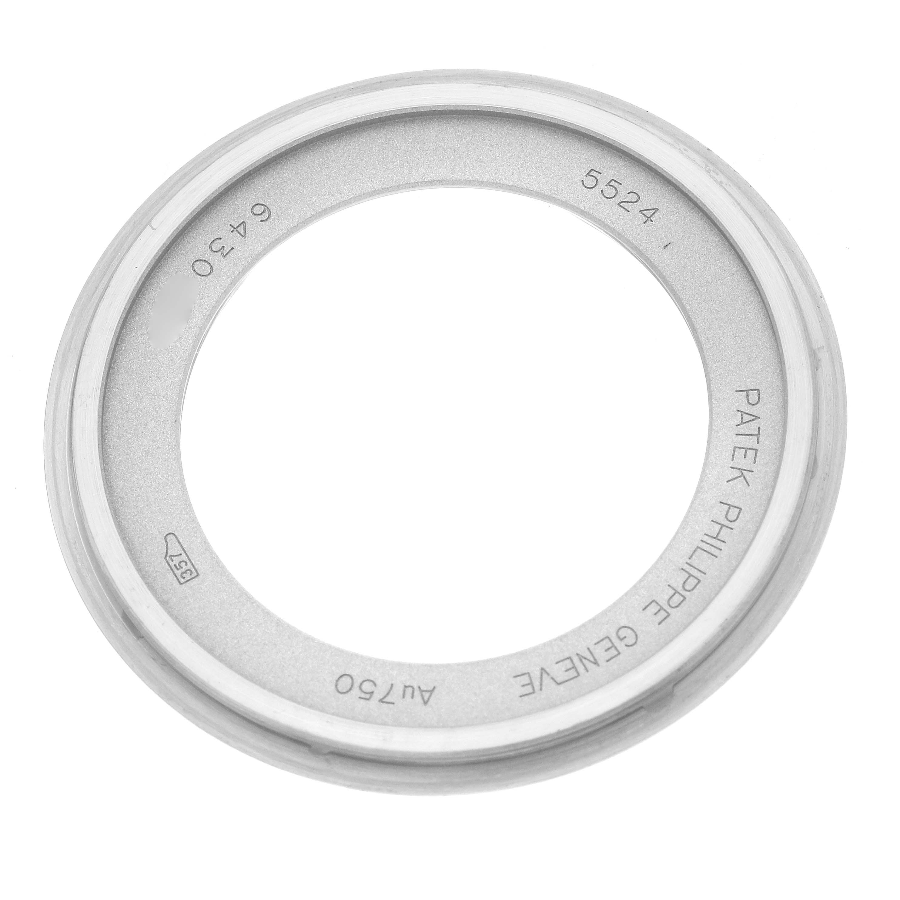 The image shows a Patek Philippe Calatrava 5524G Men's White Gold Blue Dial bezel, viewed from above, displaying engravings and numbers.