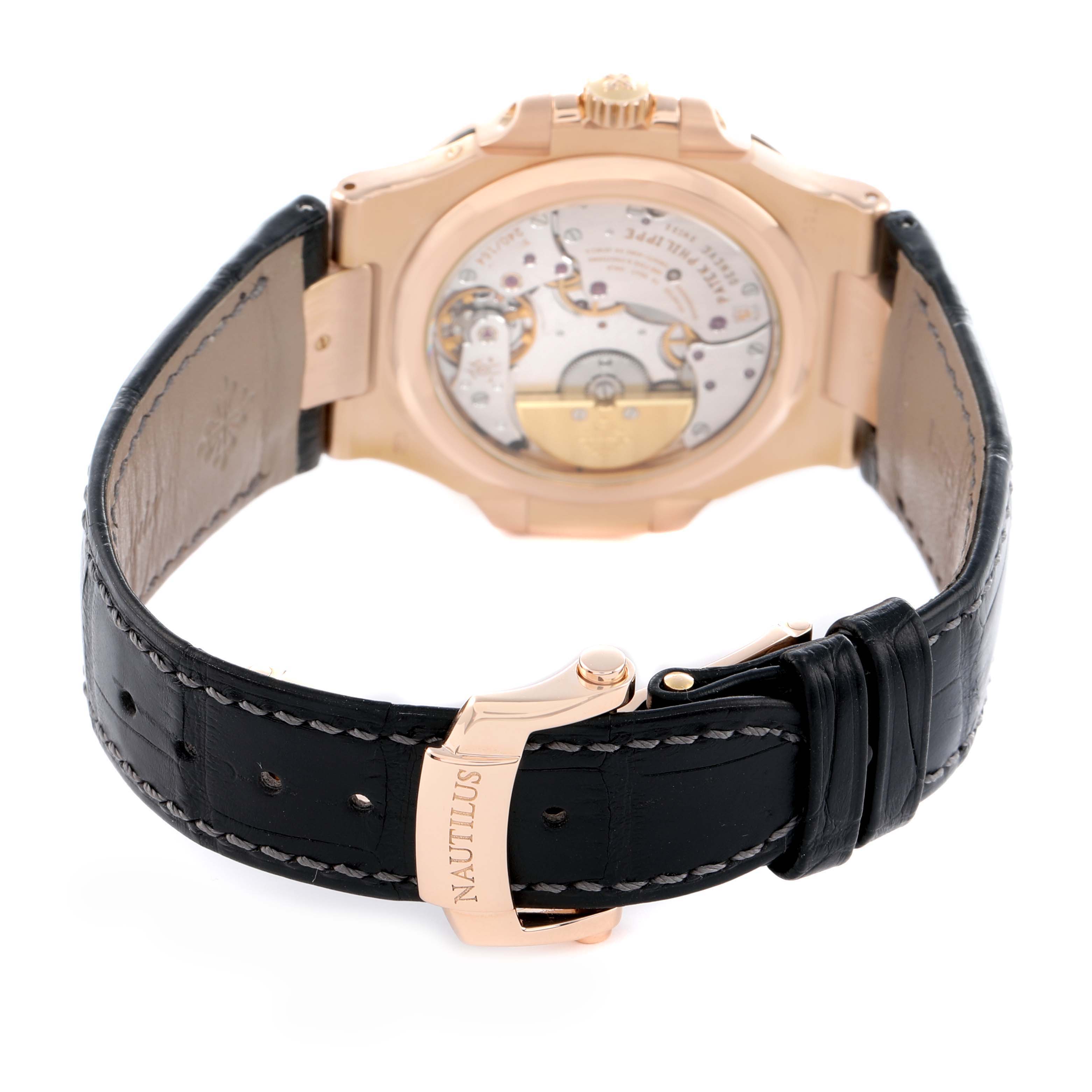 The image shows the back view of a Patek Philippe Nautilus 5712R-001 Men's Rose Gold Brown Dial watch, highlighting the movement and deployment clasp.