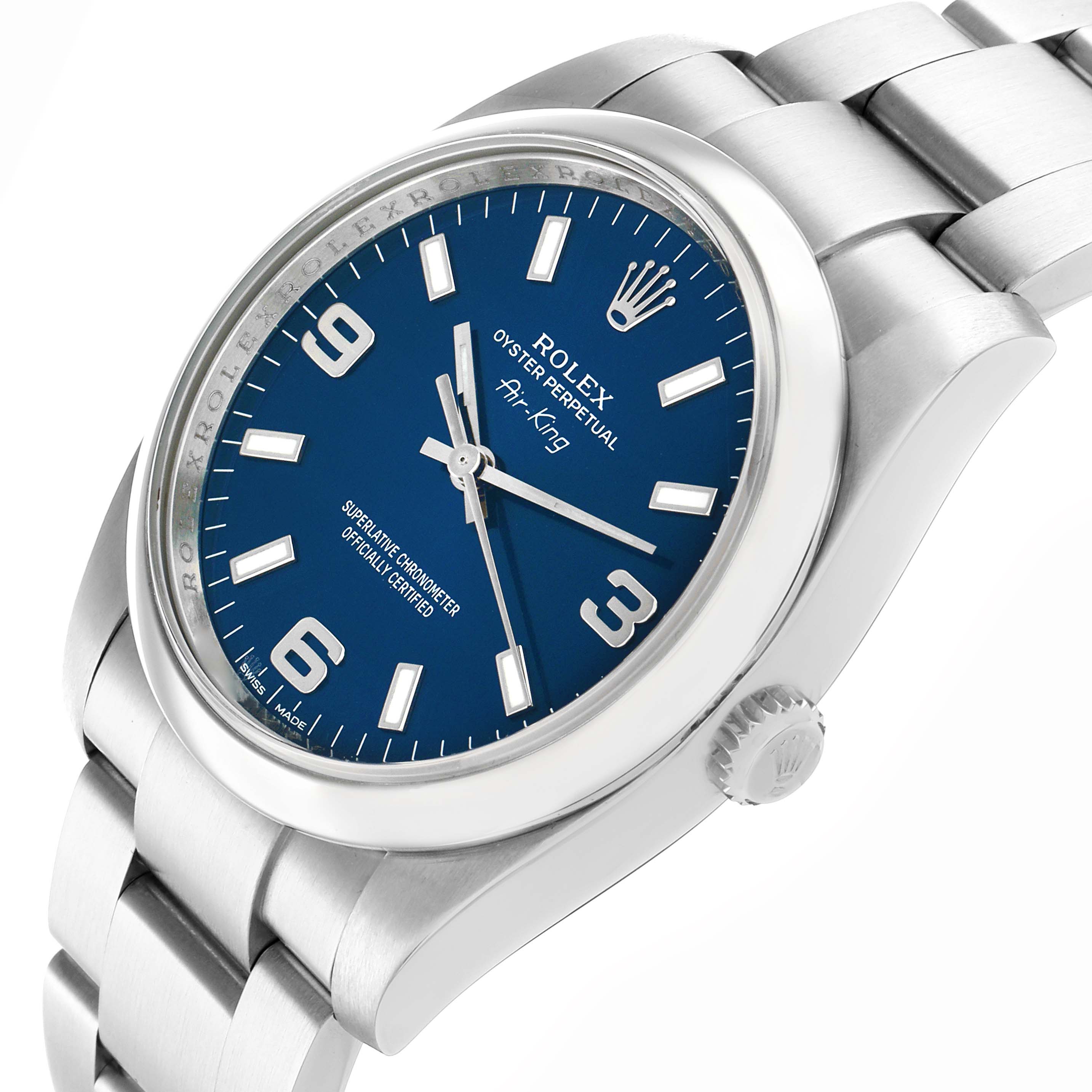The Rolex Air-King 114200 Men's Stainless Steel Blue Dial watch is shown at a slight side view, highlighting the dial, bezel, crown, and part of the bracelet.