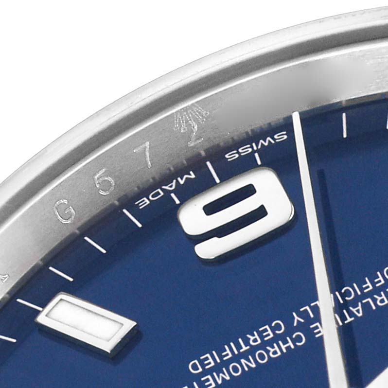 The image shows a close-up of the Rolex Air-King 114200 Men's Stainless Steel Blue Dial watch, focusing on the dial, part of the bezel, and the numeral 9.