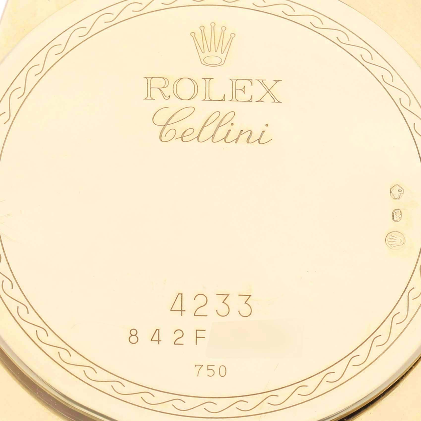 This image shows the case back of a Rolex Cellini 4233 Men's Yellow Gold White Dial 4233 Men's Yellow Gold White Dial watch, showcasing the engraved model name, brand, and various markings.