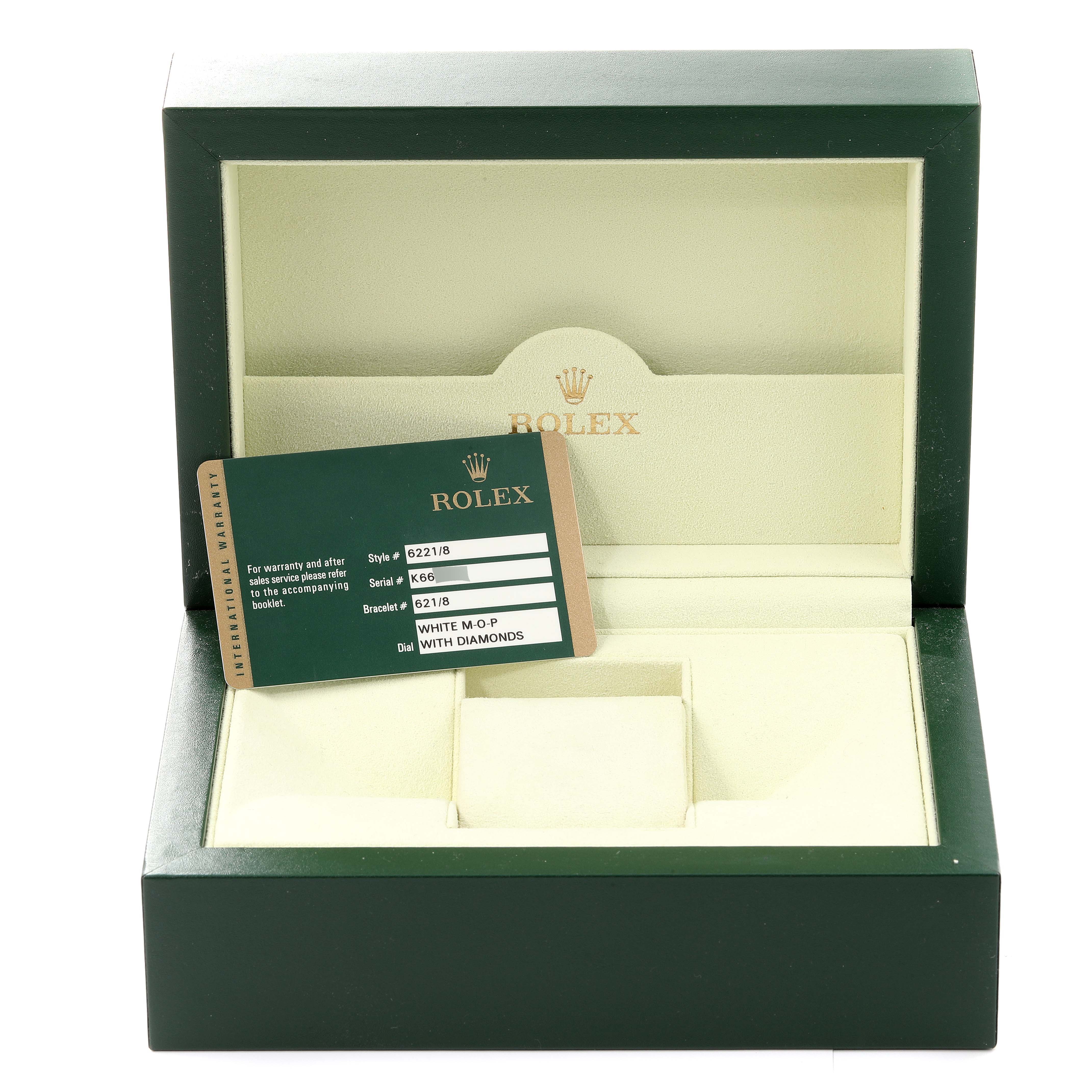 The image shows an empty Rolex Cellini 6221/8 Women's Yellow Gold Mother of Pearl Dial 6221/8 Women's Yellow Gold Mother of Pearl Dial watch box with a warranty card placed inside it.