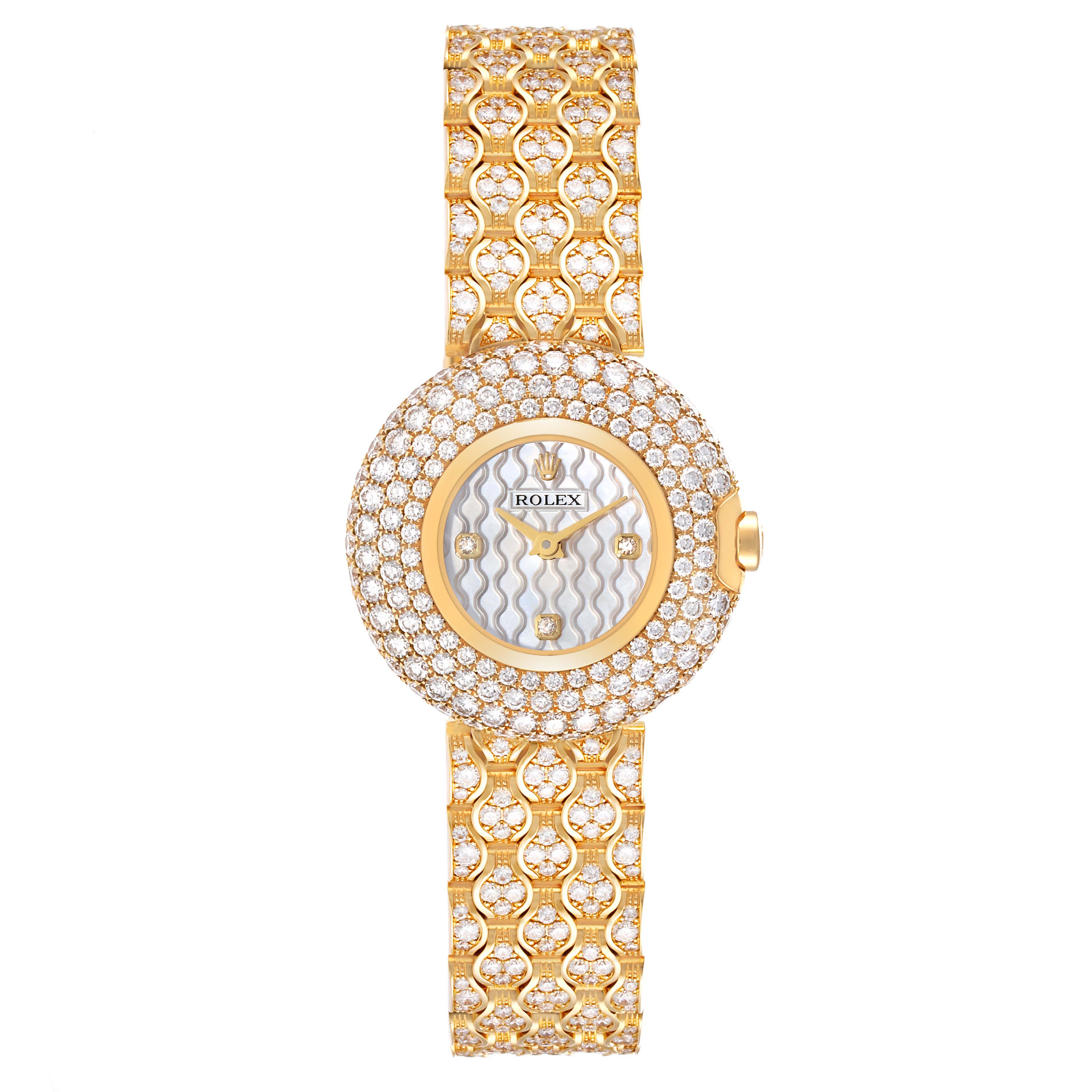 The Rolex Cellini 6221/8 Women's Yellow Gold Mother of Pearl Dial 6221/8 Women's Yellow Gold Mother of Pearl Dial watch is shown from a top-down angle, displaying its intricate gold and diamond-crusted dial and bracelet.
