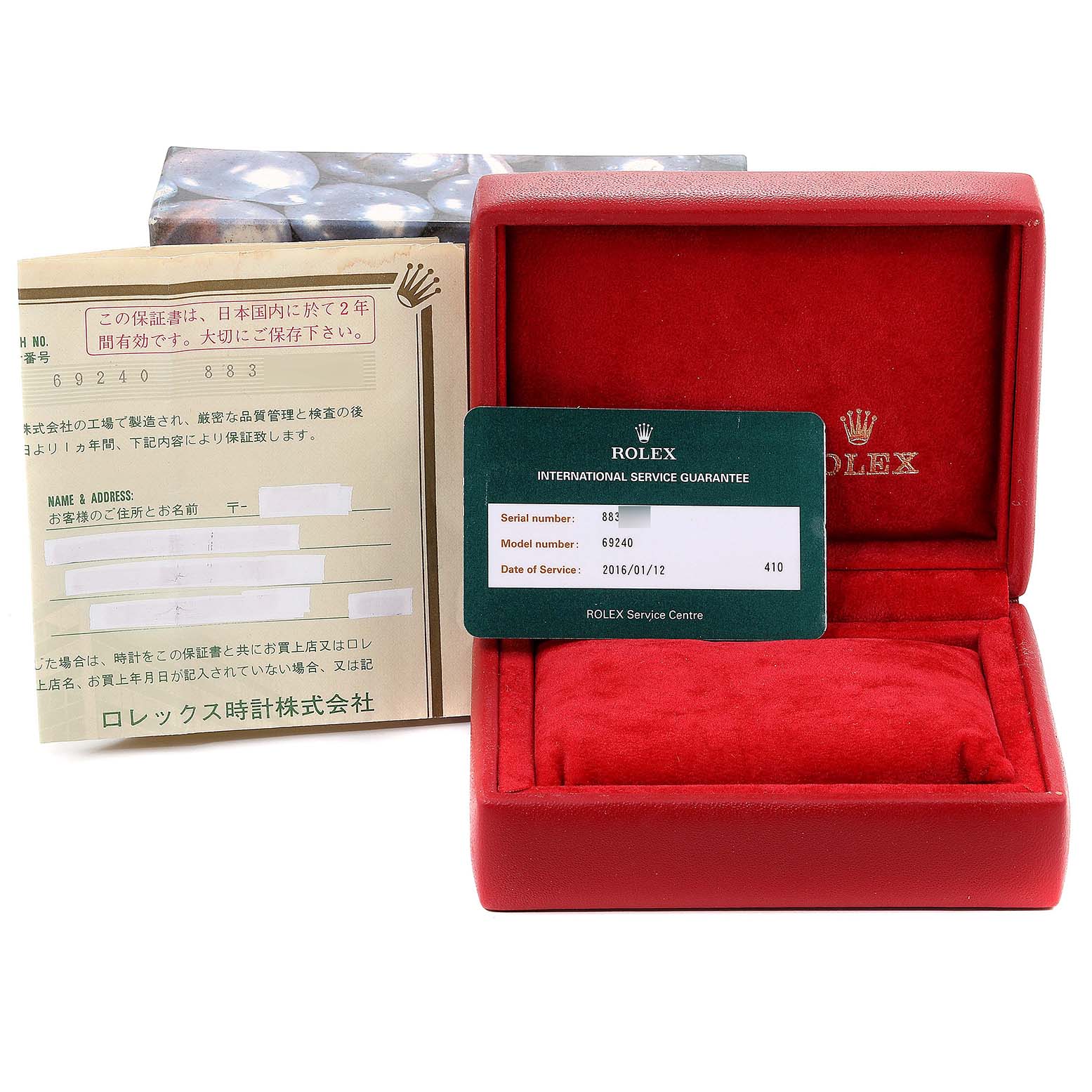 The image shows a Rolex Date 69240 Women
s Stainless Steel Pink Dial 69240 Women
s Stainless Steel Pink Dial model box and international service guarantee card, along with paperwork.