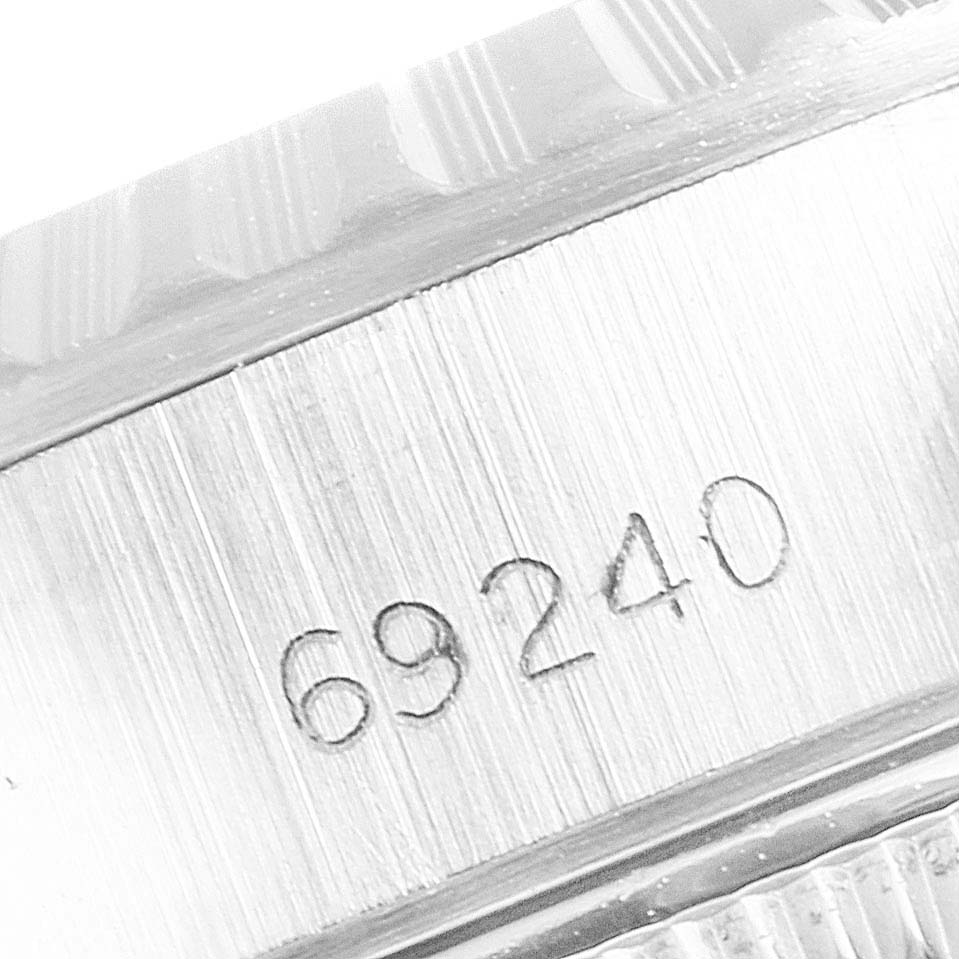 The image shows a close-up of the side of a Rolex Date 69240 Women
s Stainless Steel Pink Dial 69240 Women
s Stainless Steel Pink Dial model watch, specifically focusing on the engraved reference number "69240."