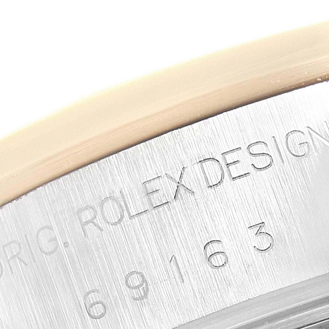 This close-up image shows part of the bezel and engraved case side of a Rolex Datejust 69163 Women's Steel and Gold (two tone) Champagne Dial 69163 Women's Steel and Gold (two tone) Champagne Dial model.