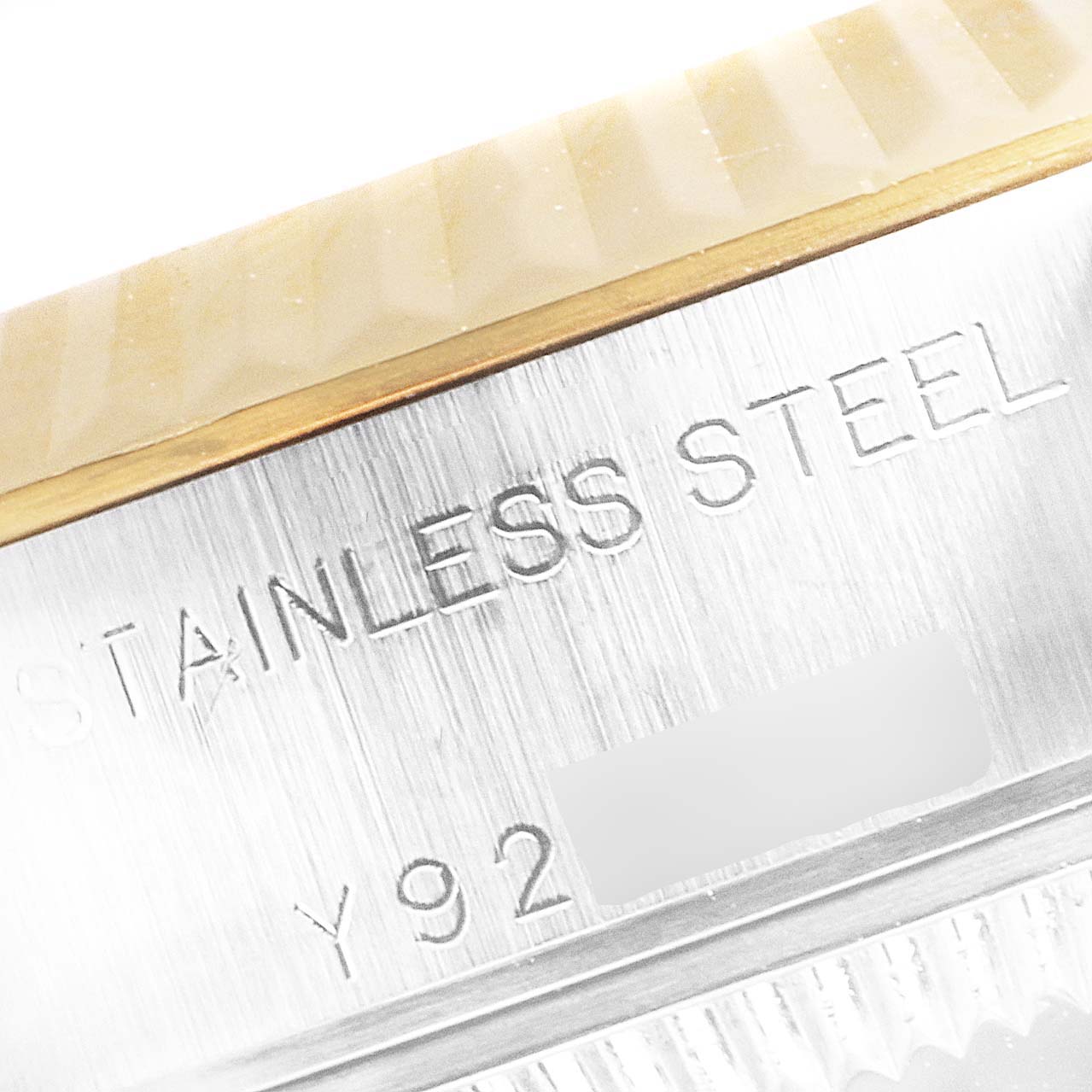 This close-up image of the Rolex Datejust 79173 Women's Steel and Gold (two tone) Silver Dial 79173 Women's Steel and Gold (two tone) Silver Dial shows the stainless steel case and model number engraving.