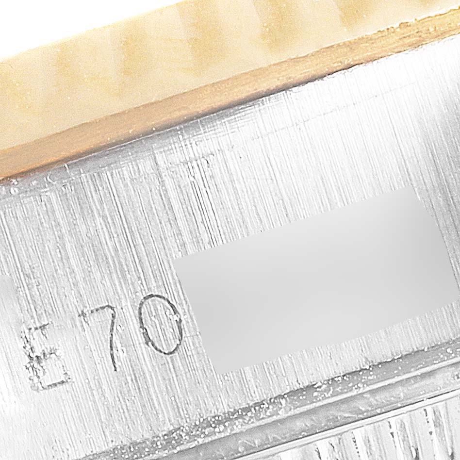 This image shows a close-up of the serial number engraved on the side of a Rolex Datejust 69173 Women's Steel and Gold (two tone) Champagne Dial 69173 Women's Steel and Gold (two tone) Champagne Dial watch case.