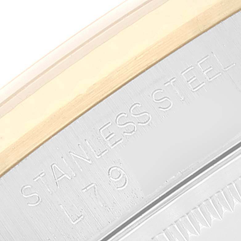 The image shows a close-up of the case side of a Rolex Datejust 16233 Men's Steel and Gold (two tone) Blue Dial 16233 Men's Steel and Gold (two tone) Blue Dial watch, highlighting the "STAINLESS STEEL" engraving.