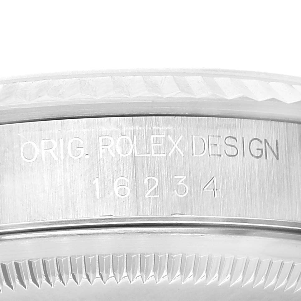 This image shows a close-up of the case side of a Rolex Datejust 16234 Men's Stainless Steel White Dial 16234 Men's Stainless Steel White Dial model, featuring the model number and "Orig. Rolex Design" engraved on it.