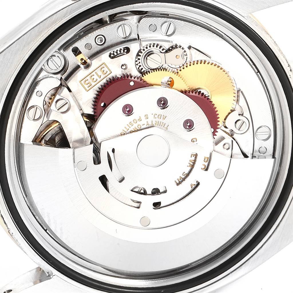This image shows the internal mechanism and movement parts of the Rolex Datejust 116243 Men's Steel and Gold (two tone) Mother of Pearl Dial 116243 Men's Steel and Gold (two tone) Mother of Pearl Dial watch from a back view angle.