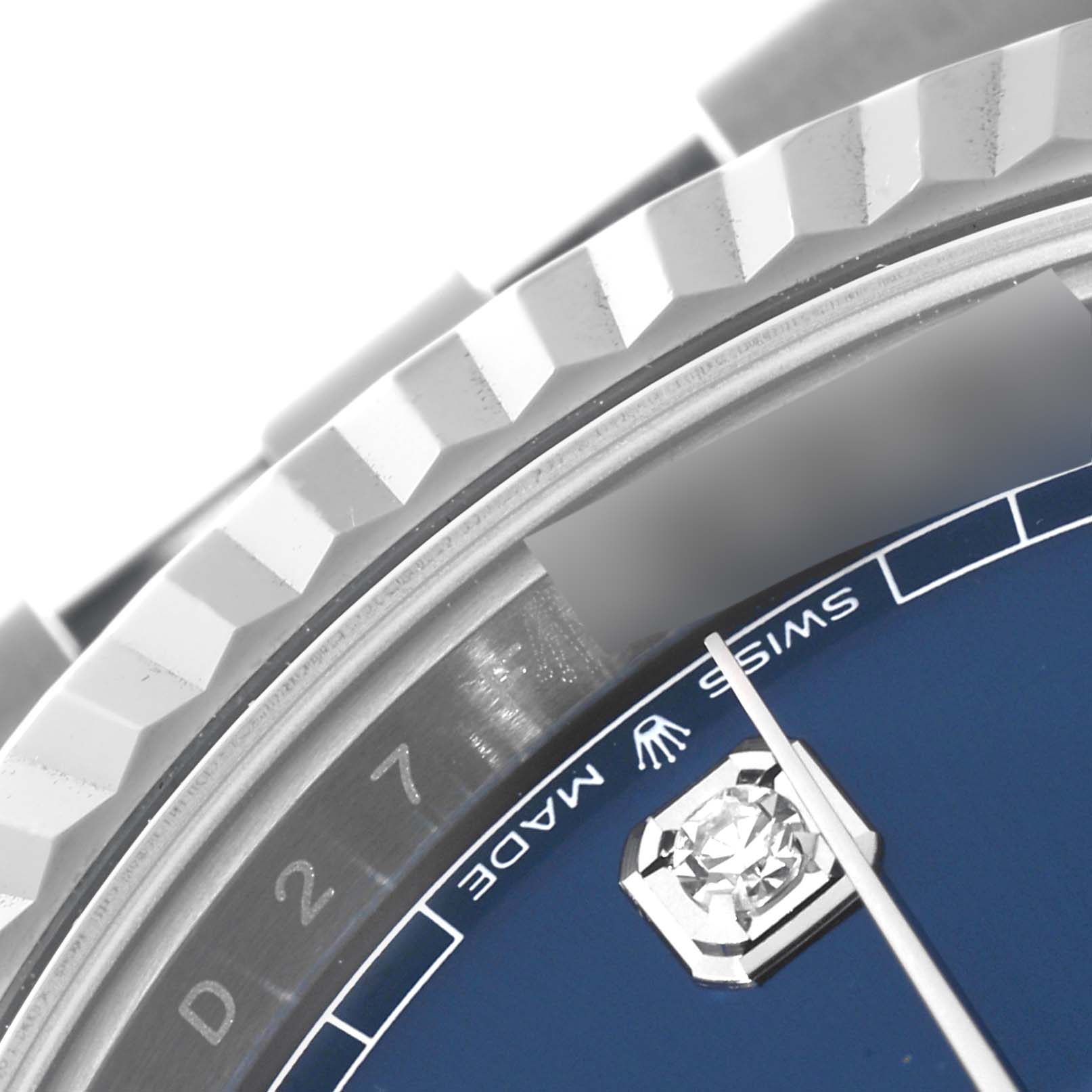 This close-up of the Rolex Datejust 41 126334 Men's Stainless Steel Blue Dial 126334 Men's Stainless Steel Blue Dial showcases the fluted bezel, part of the blue dial, minute hand, and diamond hour marker.