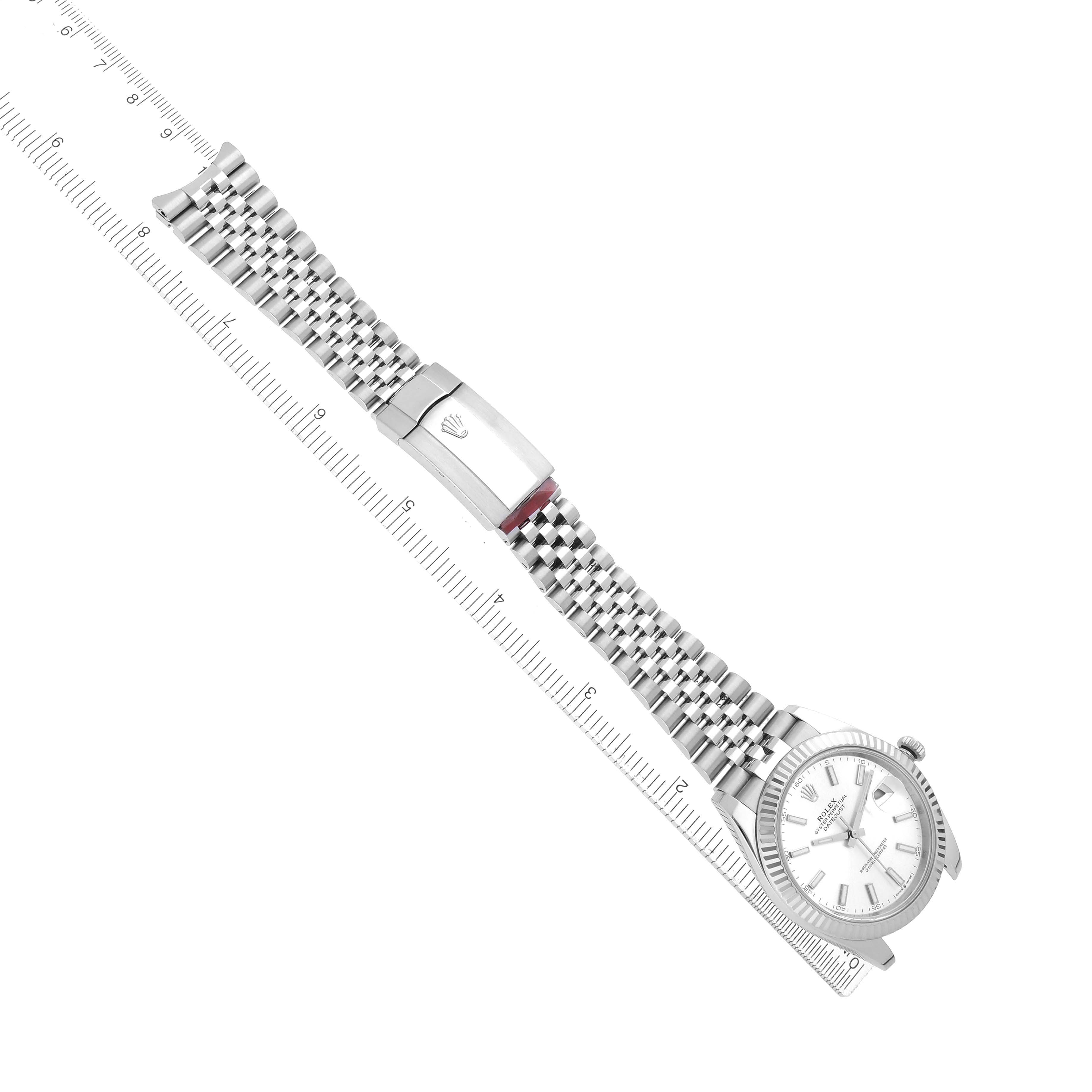 The Rolex Datejust 41 126334 Men
s Stainless Steel Silver Dial is shown from the top view, displaying the full bracelet and clasp alongside a ruler for scale.