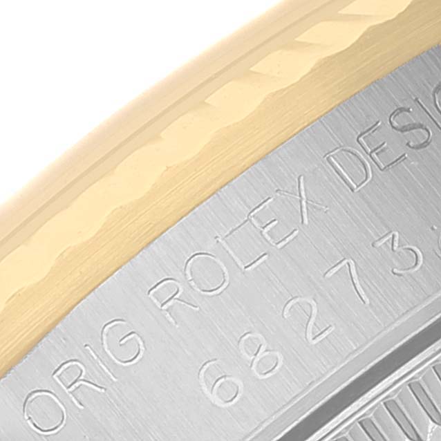 This close-up image shows the engraved bezel and part of the case of a Rolex Datejust 68273 Women
s Stainless Steel Champagne Dial 68273 Women
s Stainless Steel Champagne Dial watch, highlighting its design details.