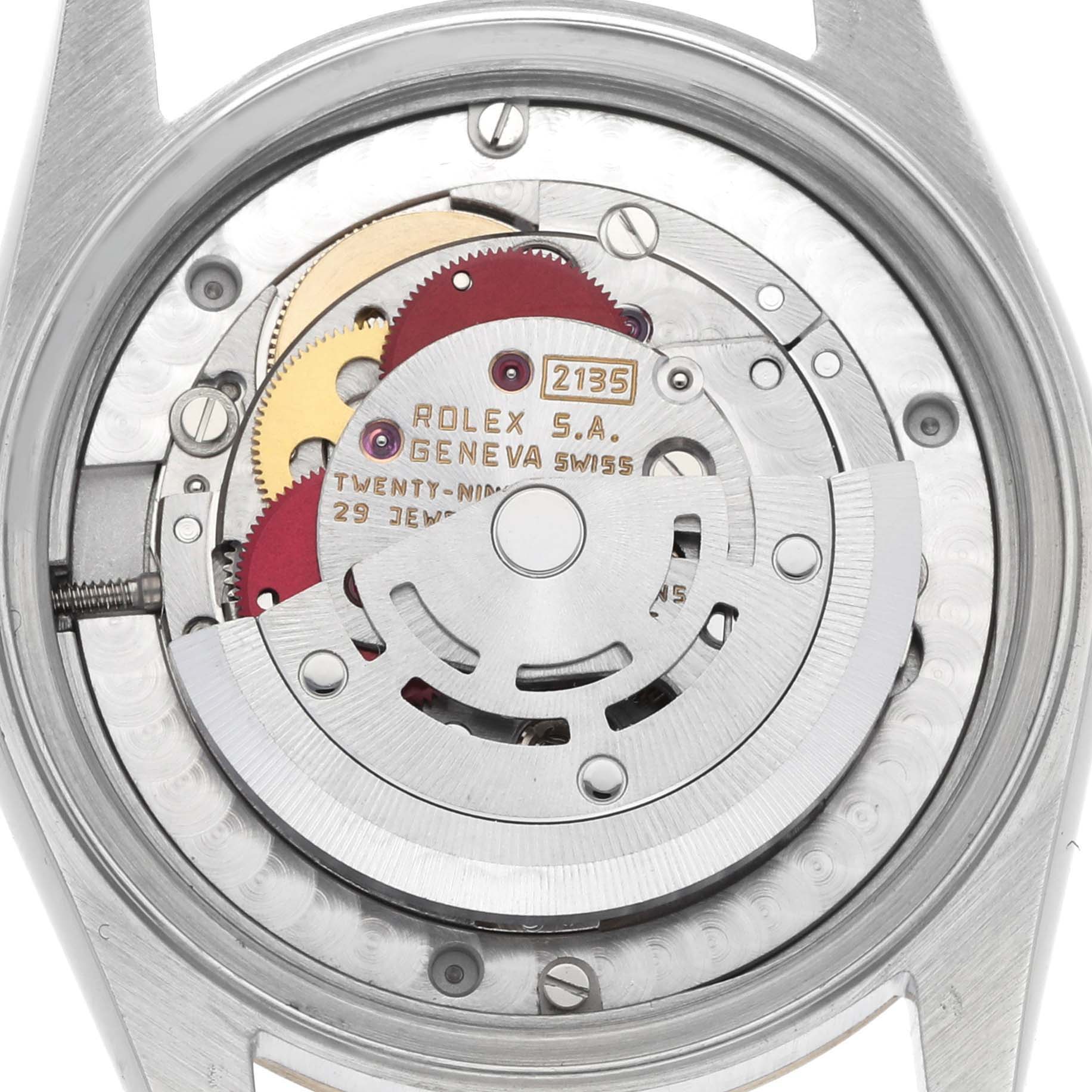 The image shows the back view of a Rolex Mid-Size 68273 Women
s Steel and Gold (two tone) Champagne Dial model, displaying its intricate movement components.