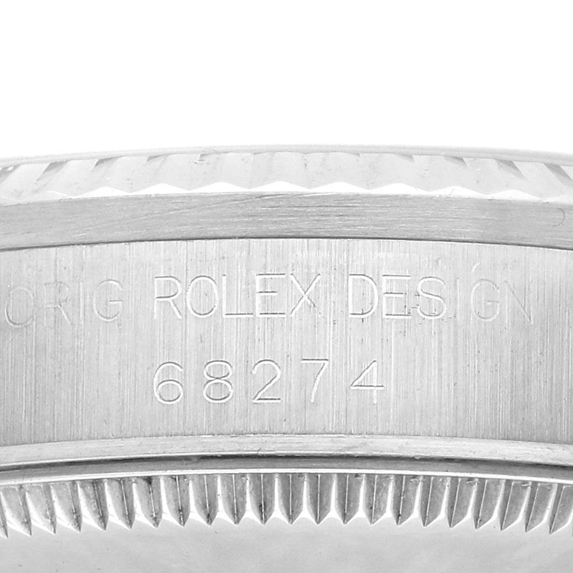 The image shows a close-up of the side of a Rolex Mid-Size 68274 Women's Stainless Steel White Dial model, featuring the engraved model number and serrated bezel edge.