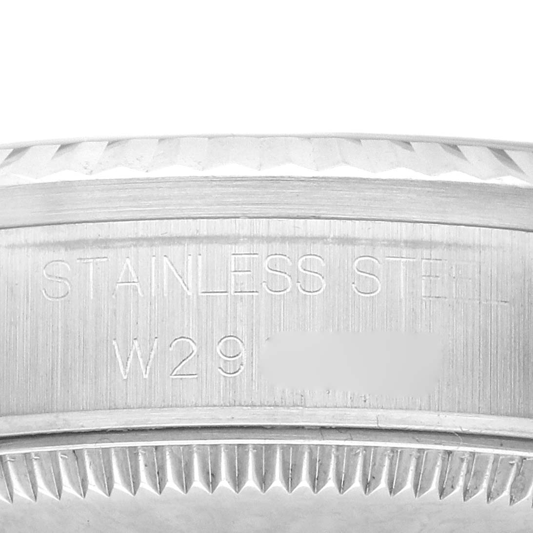 The image shows a close-up of the side of a Rolex Mid-Size 68274 Women's Stainless Steel White Dial watch, highlighting the stainless steel material and engraved text.