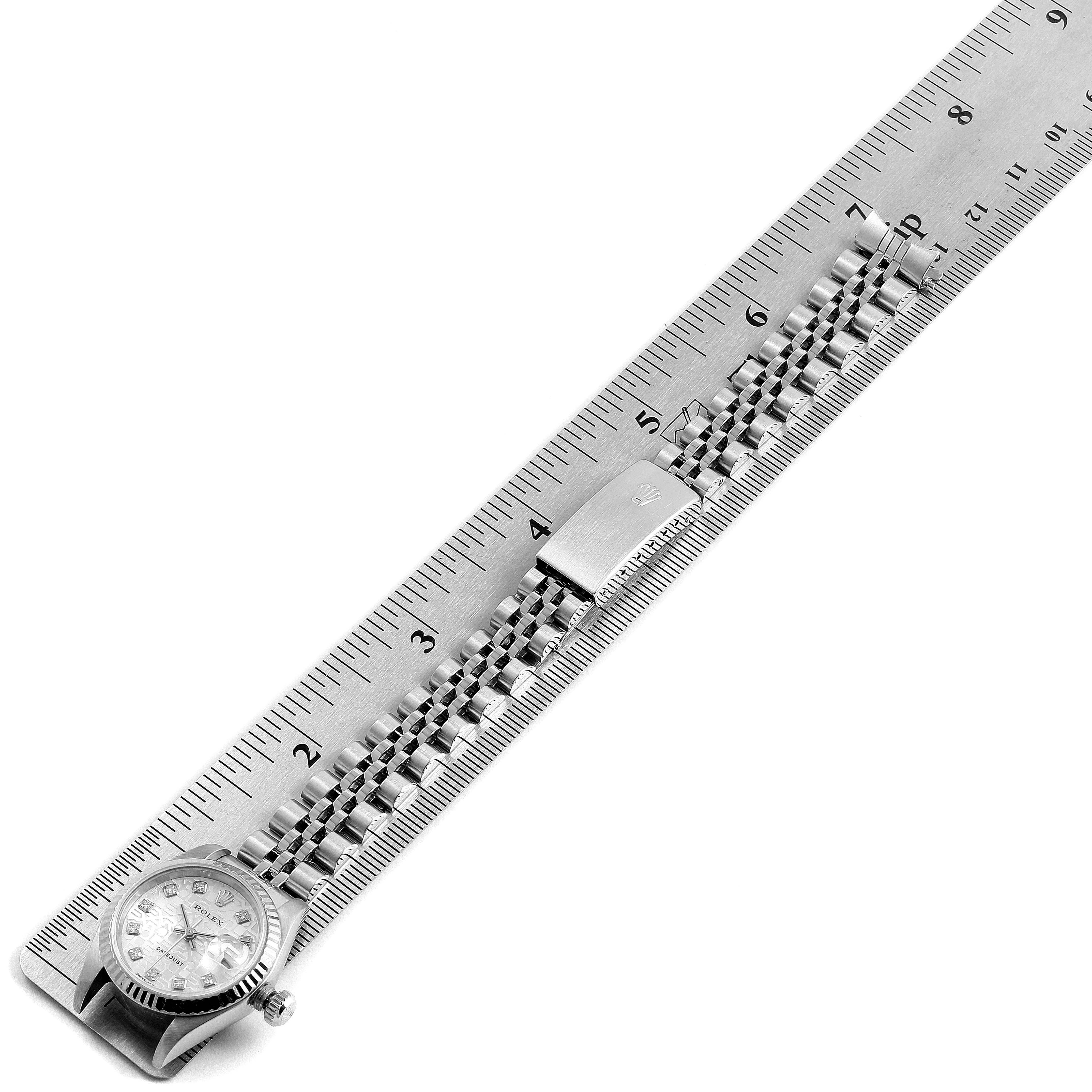 The image shows a Rolex Datejust 79174 Women's Stainless Steel Silver Dial 79174 Women's Stainless Steel Silver Dial watch laid flat alongside a ruler, displaying the watch face, crown, and bracelet with clasp.