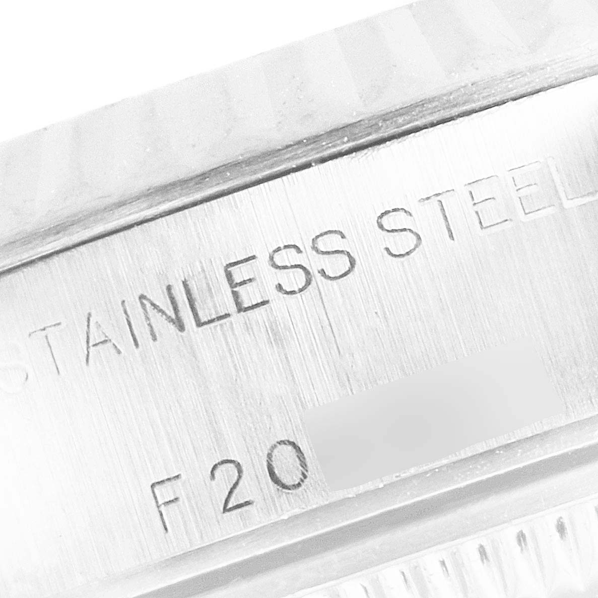 This image shows a close-up of the edge and engravings on the stainless steel casing of a Rolex Datejust 79174 Women's Stainless Steel Silver Dial 79174 Women's Stainless Steel Silver Dial watch.