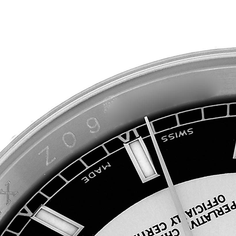 The image shows a close-up of the upper part of a Rolex Datejust 116234 Men
s Stainless Steel Black Dial watch face, including the chapter ring and some hour markers.