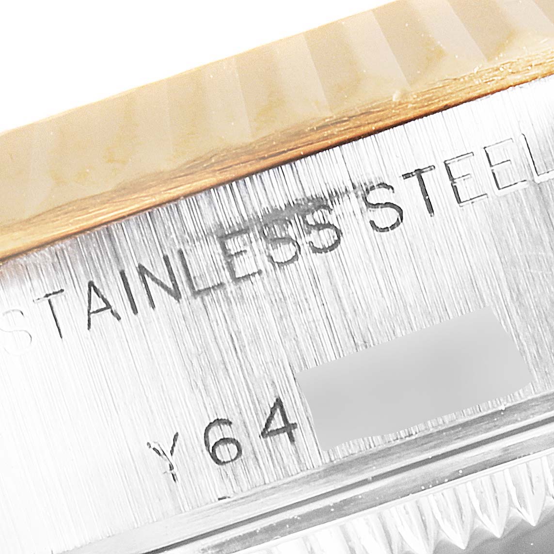 This close-up image shows the bevel and part of the stainless steel case with engravings of the Rolex Datejust 79173 Women's Stainless Steel Silver Dial 79173 Women's Stainless Steel Silver Dial model.