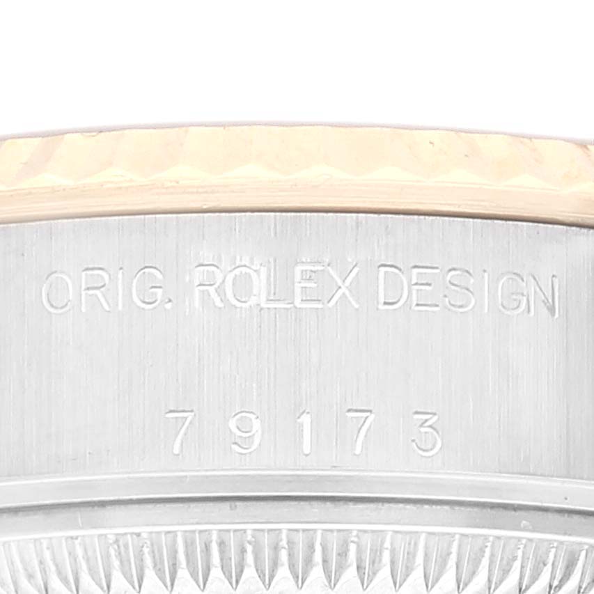 The image shows a close-up of the model number and "ORIG. ROLEX DESIGN" engraving on the case of a Rolex Datejust 79173 Women's Steel and Gold (two tone) Champagne Dial 79173 Women's Steel and Gold (two tone) Champagne Dial watch.