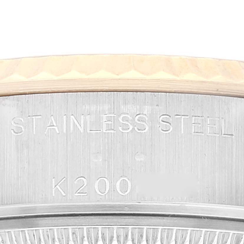 The image shows a close-up of the side of a Rolex Datejust 79173 Women's Steel and Gold (two tone) Champagne Dial 79173 Women's Steel and Gold (two tone) Champagne Dial watch, highlighting the stainless steel engraving.