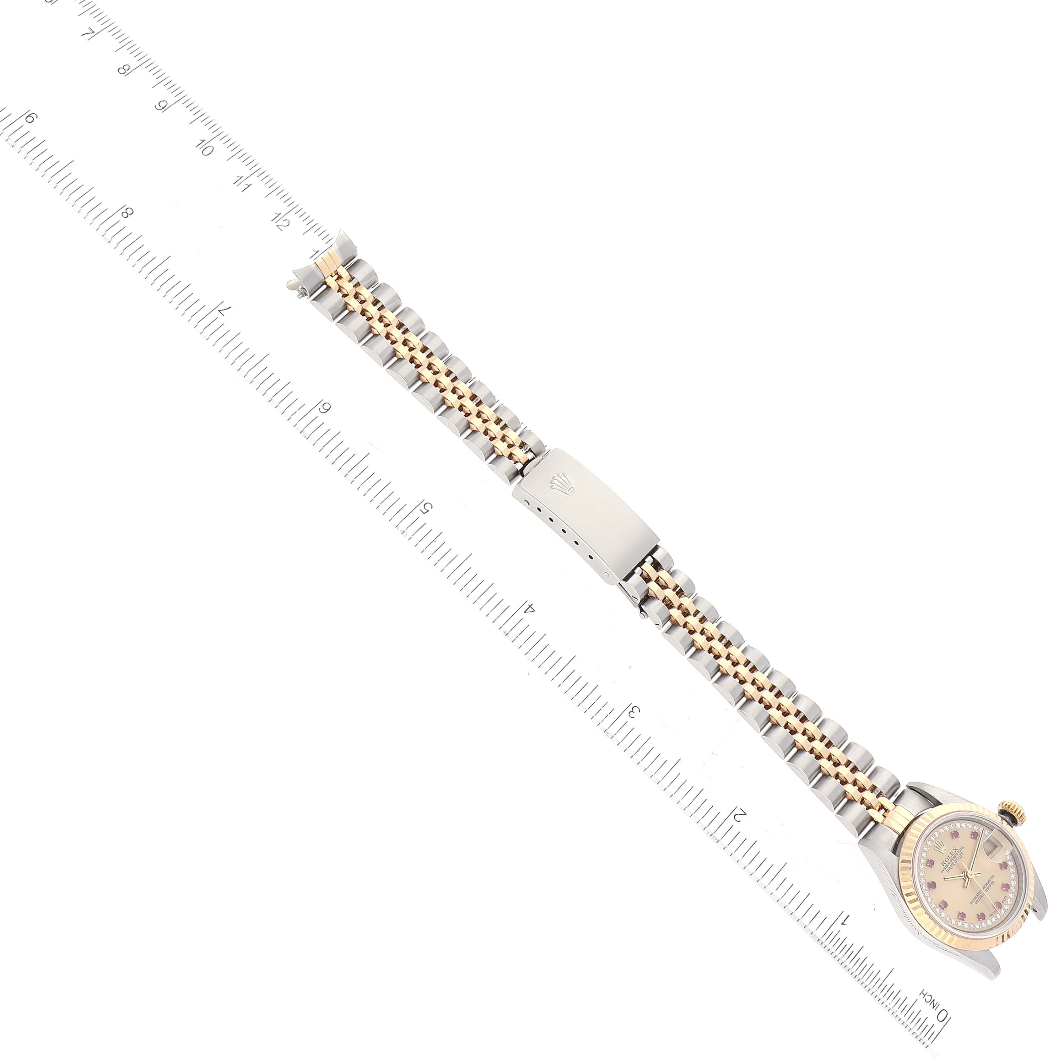 The image shows a side view of a Rolex Datejust 79173 Women's Steel and Gold (two tone) Champagne Dial 79173 Women's Steel and Gold (two tone) Champagne Dial watch, highlighting its bracelet and clasp next to a ruler.