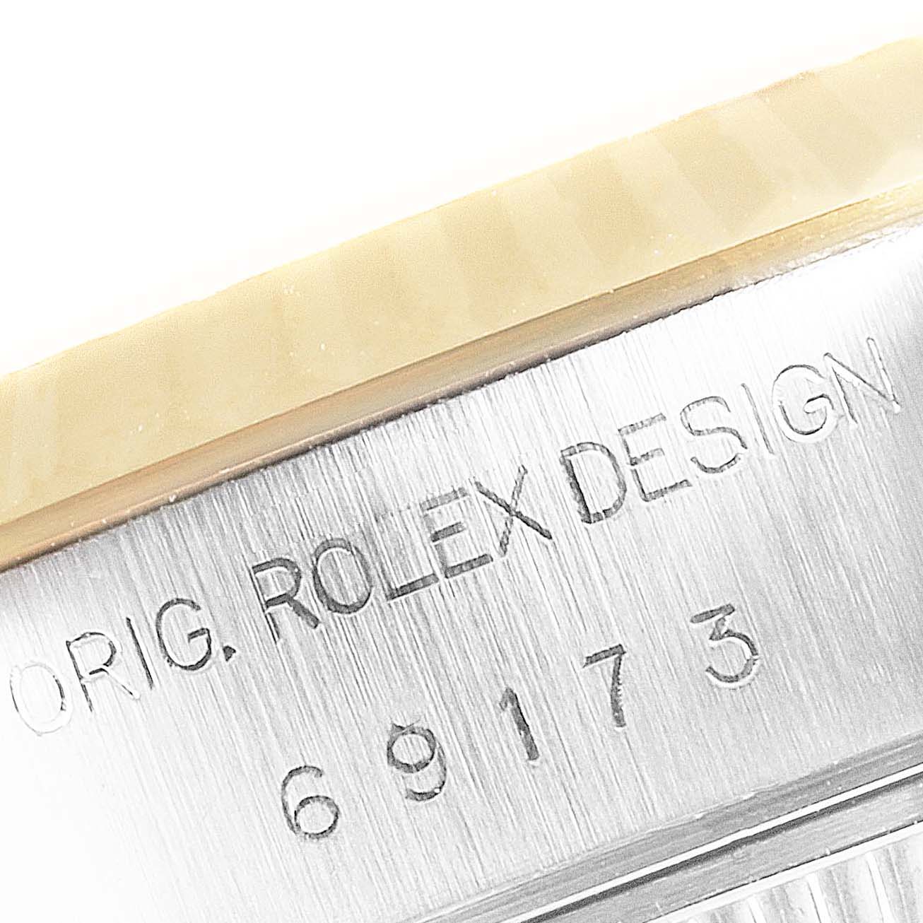 The image shows a close-up of the case side of a Rolex Datejust 69173 Women's Steel and Gold (two tone) White Dial 69173 Women's Steel and Gold (two tone) White Dial watch, displaying the model number and "ROLEX DESIGN" engraving.