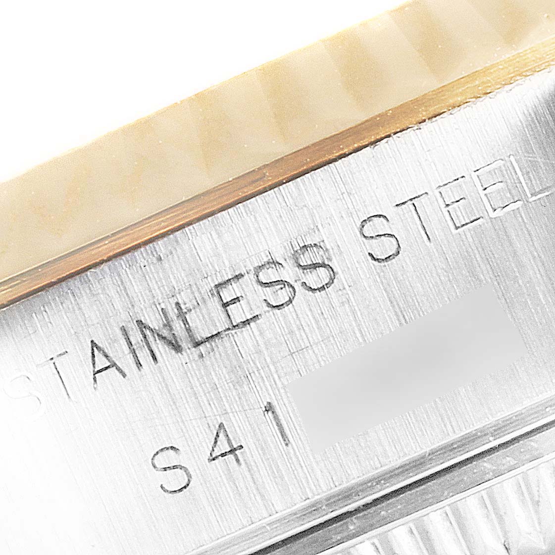 The image shows a close-up angle of the side of a Rolex Datejust 69173 Women's Steel and Gold (two tone) White Dial 69173 Women's Steel and Gold (two tone) White Dial watch, highlighting the "Stainless Steel" engraving.